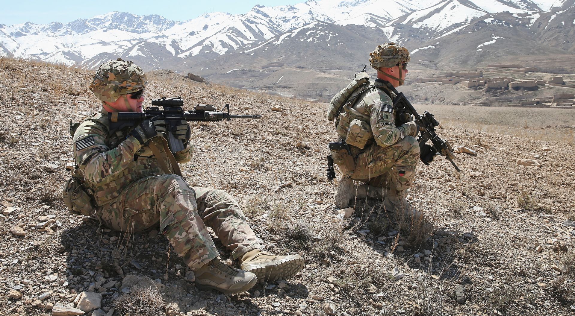 PUL-E ALAM, AFGHANISTAN - MARCH 31:  CSM Brian Hamm from Plano, Texas (L) and 1LT John Levulis from Buffalo, New York with the U.S. Army's 2nd Battalion 87th Infantry Regiment, 3rd Brigade Combat Team, 10th Mountain Division patrol up a mountainside near Forward Operating Base (FOB) Shank on March 31, 2014 near Pul-e Alam, Afghanistan. The primary mission of soldiers with the 10th Mountain Division stationed at FOB Shank is to advise and assist Afghan National Security Forces in the region. Security is at a heightened state throughout Afghanistan as the nation prepares for the April 5th presidential election.  (Photo by Scott Olson/Getty Images)