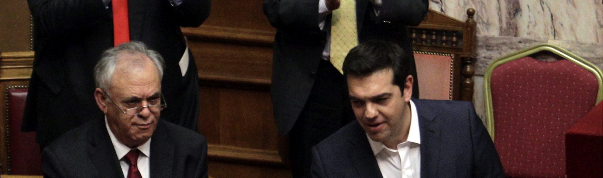 epa04968018 Members of the government applaud Greek Prime Minister Alexis Tsipras (R) after the end of his speech before confidence vote at the parliament in Athens, Greece, 07 October 2015. The debate on the government policy statements in Parliament plenum will be completed on Wednesday midnight. Afterwards the parliament will be asked to give a vote of confidence to the government.  EPA/ALEXANDROS VLACHOS