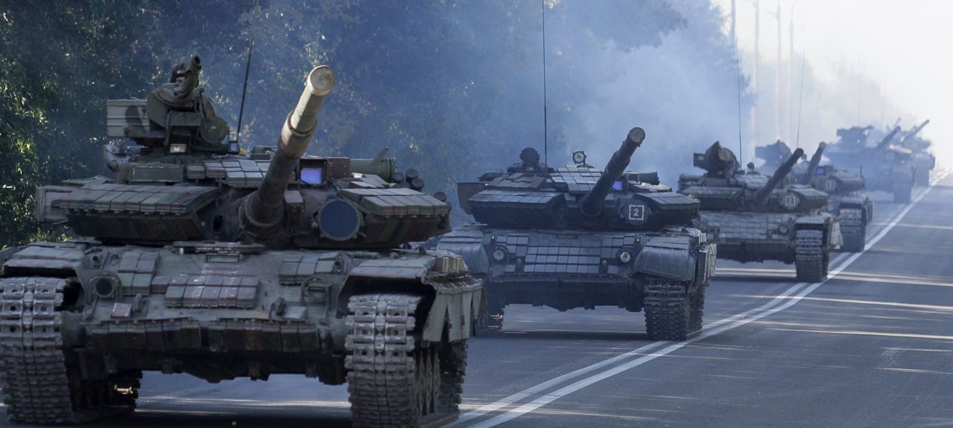 epa04961639 A convoy of pro-Russian separatist tanks drive on a road during, as pro-Russian separatists said, withdrawing their heavy weapons from the front line, in Aleksandrovsk town, near Luhansk, Ukraine, 03 October 2015. Leaders from four countries defended a long-flouted ceasefire agreement for eastern Ukraine on Friday, as withdrawal of small-calibre arms was set to go into effect over the weekend. Ukrainian President Petro Poroshenko said the Ukrainian military would begin withdrawing guns with a calibre of less than 100 millimetres from the front lines on Saturday, describing the agreement as the most significant achievement of the talks. Russian President Vladimir Putin's spokesman, Dmitry Peskov, confirmed that the sides agreed that the withdrawal would begin 'tomorrow at midnight.' While no major breakthroughs were announced after talks lasting nearly five hours, both French President Francois Hollande and German Chancellor Angela Merkel said the region was on the right track toward meeting a peace accord signed in Minsk in February. Local elections in rebel-held areas will be postponed until observers could ensure that they would proceed legally, Hollande said after the talks in Paris. The rebel governments in Donetsk and Luhansk had planned to hold elections on October 18 and November 1, respectively. The regular regional elections in Ukraine are scheduled for October 25.  EPA/ALEXANDER ERMOCHENKO