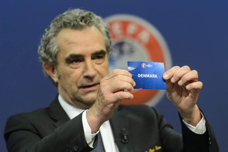 epa04982069 Dominique Rocheteau, former soccer player from France and ambassador for the UEFA EURO 2016 in France, shows a ticket with Denmark national soccer team during the draw for the play-off matches for UEFA EURO 2016 at the UEFA Headquarters, in Nyon, Switzerland, 18 October 2015.  EPA/JEAN-CHRISTOPHE BOTT