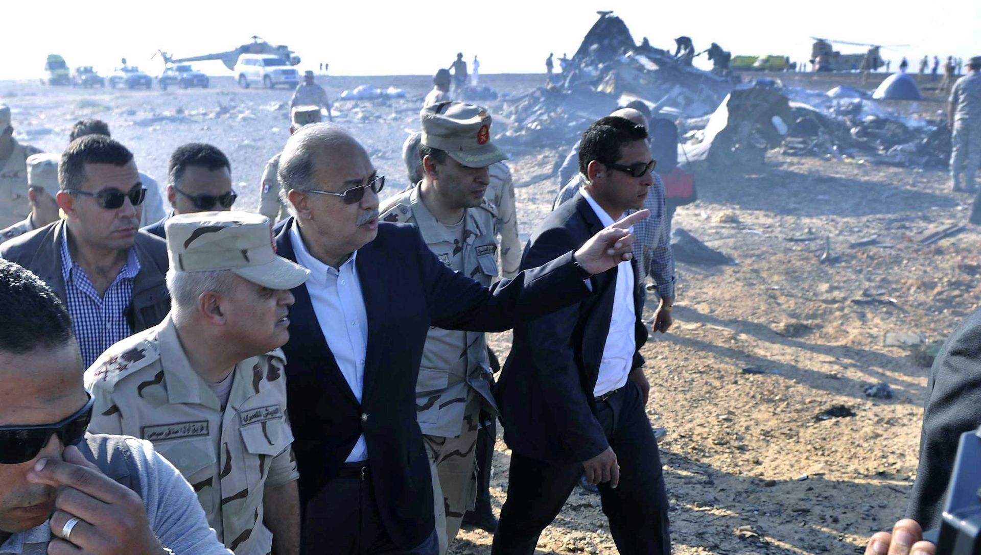 epa05005078 The Egyptian Prime Minister, Sherif Ismail (3 - L), examines the wreckage at the site of the Russian plane crash, Sinai, Egypt, 31 October 2015. According to reports the Egyptian Government has dispatched more than 45 ambulances to the crash site of the Kogalymavia Metrojet Russian passenger jet, which disappeared from raider after requesting an emergency landing early 31 October, crashing in the mountainous al-Hasanah area of central Sinai. The black box has been recovered at the site.  EPA/STR EGYPT OUT