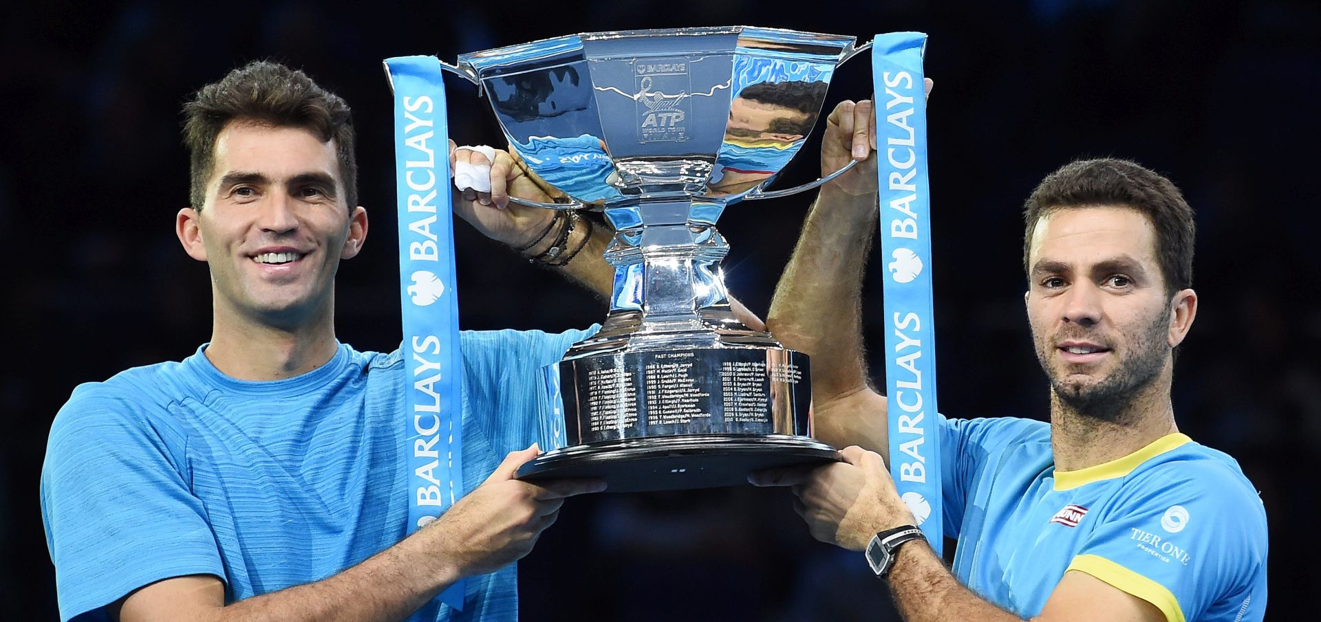 epa05037495 Horia Tecau (L) celebrates with doubles partner Jean-Julien Rojer (R) after winning the doubles final match at the ATP Tour tennis finals tournament at the O2 Arena in London, Britain, 22 November 2015.  EPA/ANDY RAIN