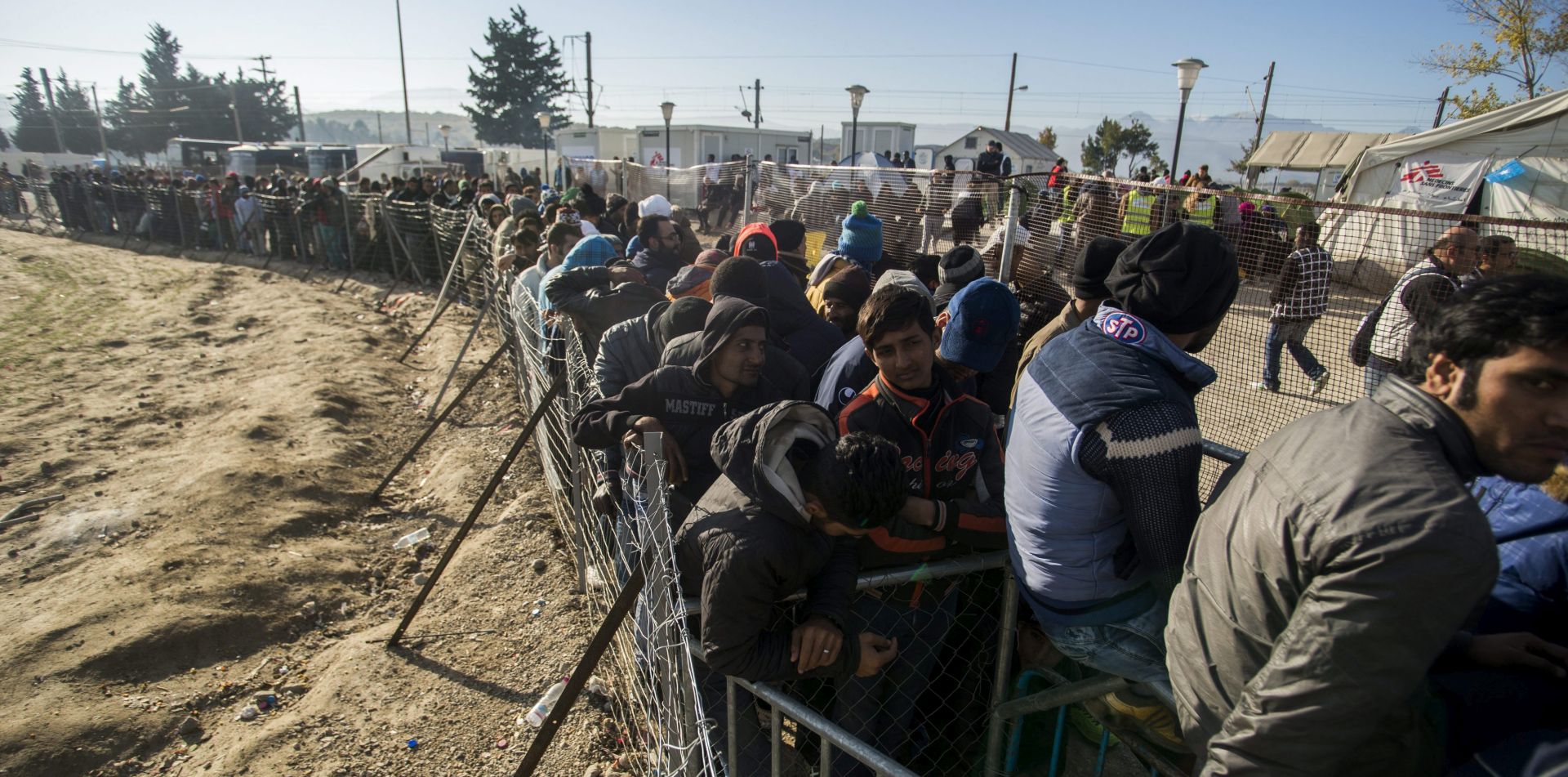 epa05058785 Migrants stand in line for food on the Greek side of the border between Greece and Macedonia, near the Greek village of Idomeni, 07 December 2015. Since October, the number of people travelling through the Balkans and on to Austria and Germany has dropped, after countries on the Balkan route stopped allowing entry to economic migrants and built their own fences.  EPA/ZOLTAN BALOGH HUNGARY OUT