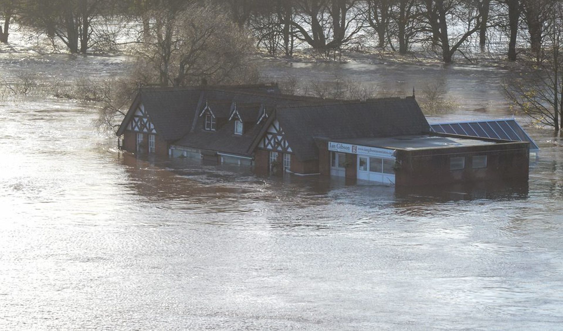 epa05057687 A handout picture made available by the British Ministry of Defence (MOD) shows partially submerged buildings, North West England, Britain, 06 December 2015. Army personnel from 2nd Battalion Duke of Lancaster's Regiment, based in Weeton Barracks near Preston, have been deployed to assist with the flooding response operation with around 350 personnel potentially available within the Battalion. Storm Desmond brought extreme weather to many other areas of northern England and Scotland as the government issued severe flood warnings for 31 areas of England and Wales, with many of the warnings along swollen rivers.  EPA/BRITISH MINISTRY OF DEFENCE/CPL MICHAEL STRACHAN MANDATORY CREDIT: CROWN COPYRIGHT HANDOUT EDITORIAL USE ONLY/NO SALES
