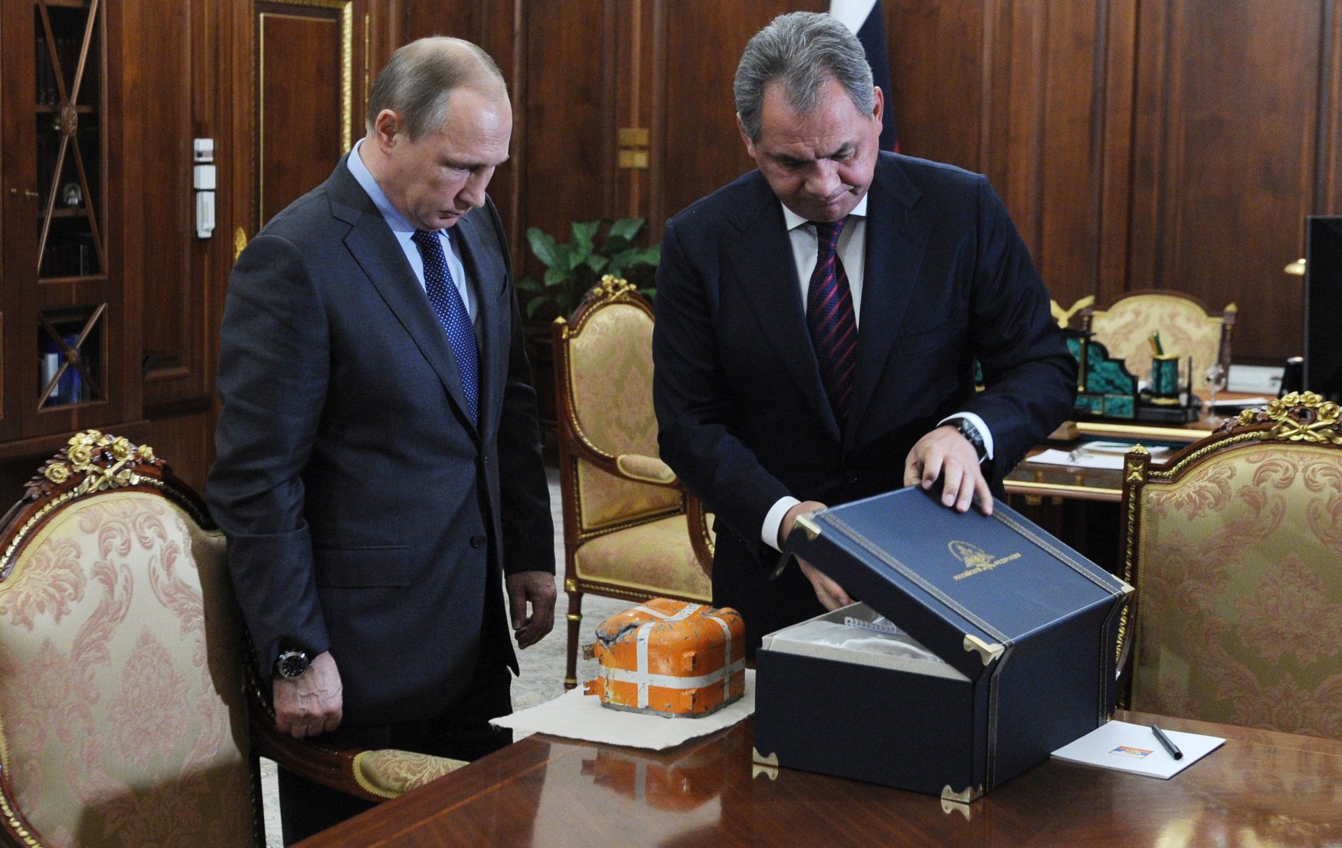 epa05060298 Russian Defense Minister Sergei Shoigu (R) introduces to Russian President Vladimir Putin (L) a flight recorder of Russian SU-24 bomber, downed in Syria by Turkish F-16 fighter, during their meeting in Novo-Ogariovo residence outside Moscow, 08 December 2015. Vladimir Putin ordered to study all the data of the recorder, in collaboration with all interested foreign specialists.  EPA/MIKHAIL KLIMENTIEV/SPUTNIK/KREMLIN POOL