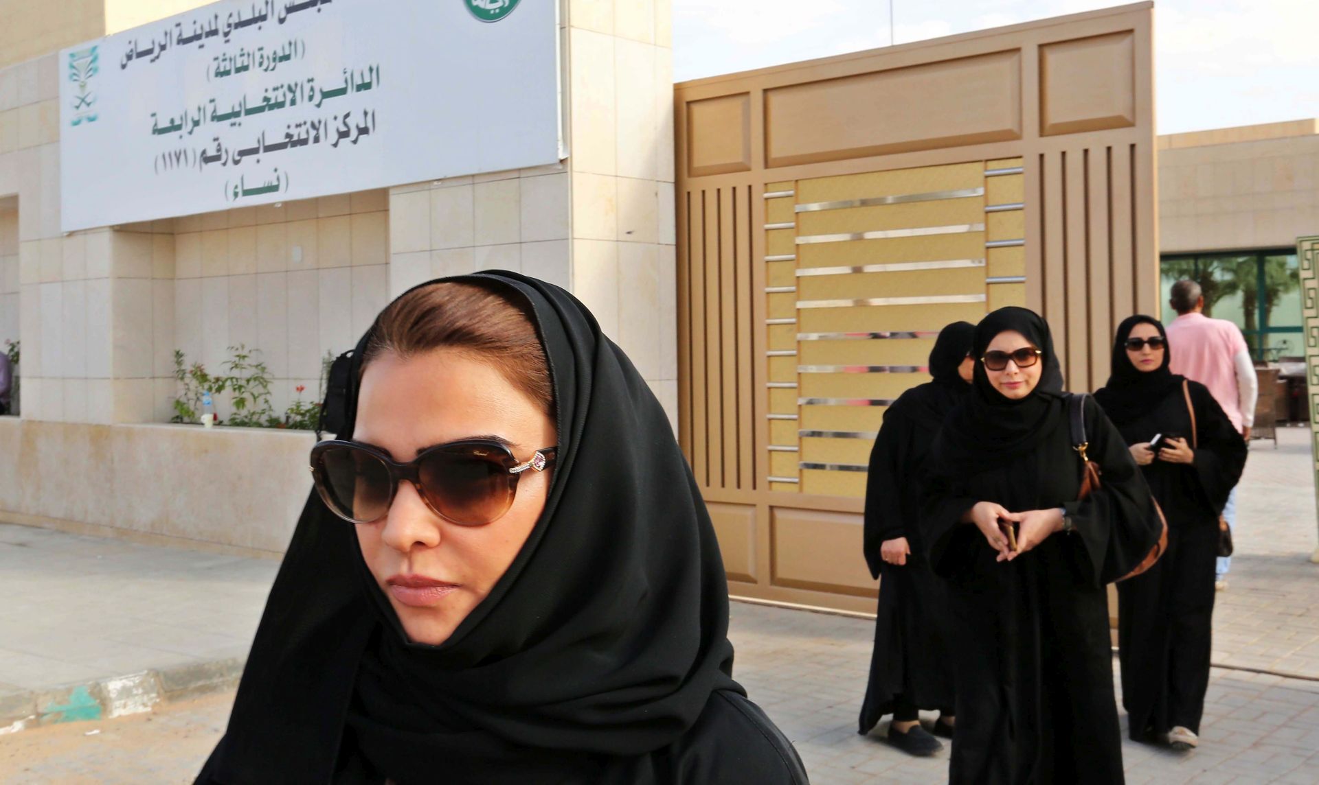 epa05066147 Saudi women leave a polling station after casting their votes in the Kigdom's municipal elections, in Riyadh, Saudi Arabia, 12 December 2015. For the first time Saudi women have been allowed to run and vote in the the country's municipal elections, regarded as a small but significant opening of the ultra conservative society to women. Though female candidates were not allowed to campaign and had to be accomapanied by a male guardian in order to be able to vote in the country where they are still not allowed by law to drive. The voting age was also lowered prior to the election from 21 to 18.  EPA/AHMED YOSRI