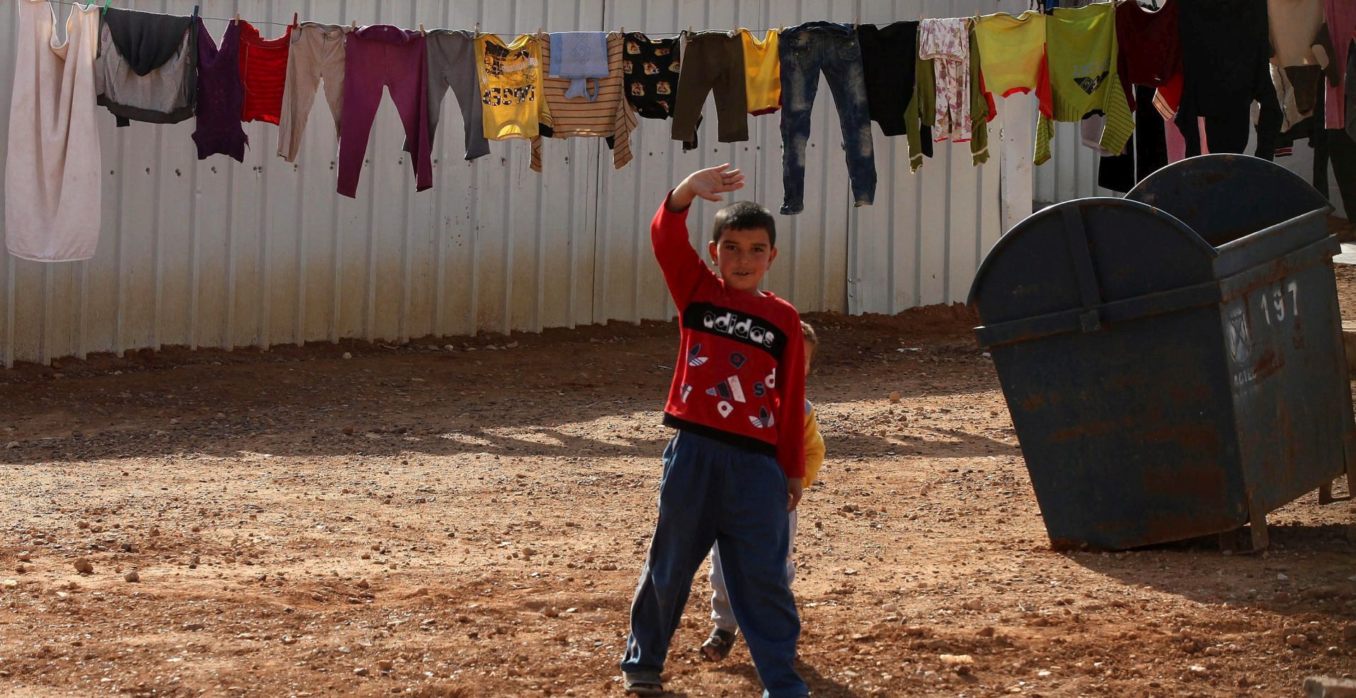 epa05135469 A Syrian child gestures at Azraq Syrian refugee camp, Jordan, 30 January 2016. Jordanian Prime Minister Abdullah Ensour visited the camp days before the Fourth international donors' conference in London to discuss the refugee crisis and ways to support them and the host countries.  EPA/JAMAL NASRALLAH