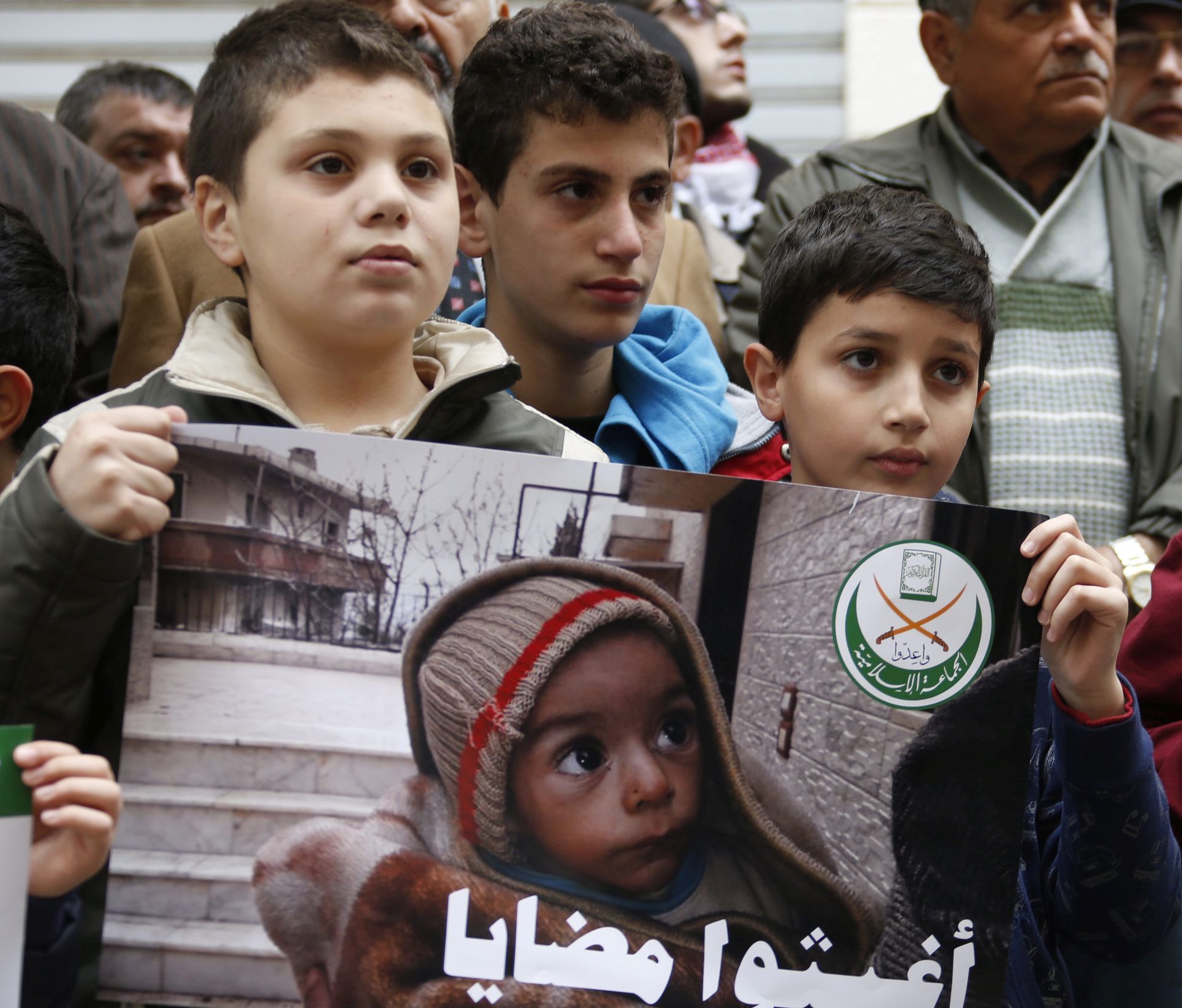 epa05092717 Supporters of Jemaah Islamiyah (Islamic Group) carry a placard depicting pictures believed to be for children from the Syrian town of Madaya and Arabic reading 'Save Madaya' during a protest in front of the International Committee of the Red Cross (ICRC) headquarters in Beirut, Lebanon, 08 January 2016. Aid agencies have received permission from the Syrian government to deliver relief supplies to the three besieged towns, Madaya, Foua and Kefraya, whose residents are reportedly starving, the Red Cross said. Madaya, a rebel-held town about 25 kilometres north-west of the capital, Damascus, has been under siege since July by forces loyal to Syrian President Bashar al-Assad, aided by fighters from the allied Lebanese Hezbollah movement.  EPA/NABIL MOUNZER