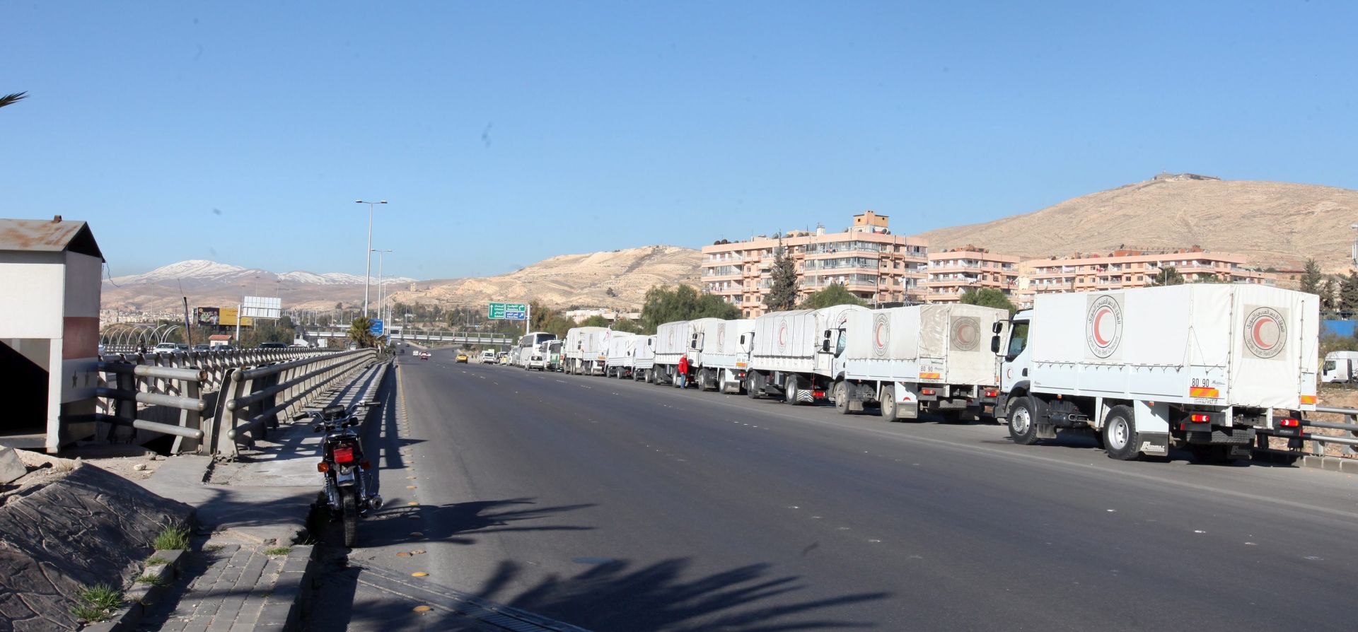 epa05165694 Trucks with relief goods stand in front of the United Nations Relief and Works Agency (UNRWA) offices in Damascus, Syria, 17 February 2016. Around 73 trucks loaded with food, infant formula and medicines, in addition to a mobile clinic and a medical team, will head to the besieged rebel-held towns of Madaya, al-Zabadani and al-Moadhamiya, as part of a UN sponsored aid operation in the war-torn country. A similar convoy of 25 trucks, a mobile clinic and a medical team, headed to the villages of Foua and Kfraya in the northern Idlib, which are besieged by rebels. The convoys are the third humanitarian aid delivery to the besieged areas after two similar efforts last month.  EPA/YOUSSEF BADAWI