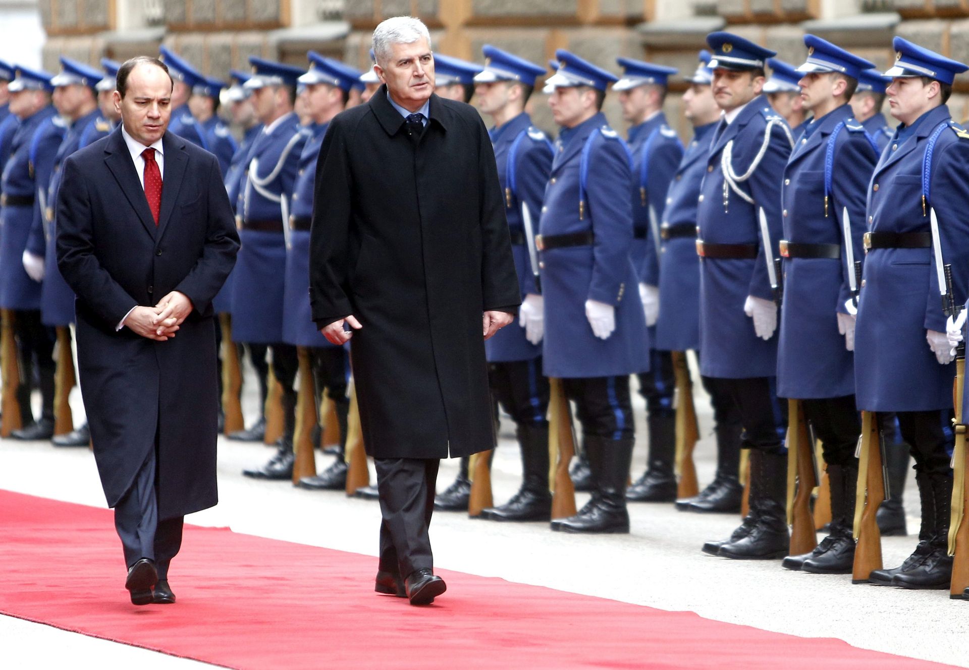 epa05177979 Albanian President Bujar Nishani (L) and Chairman of the Presidency of Bosnia and Herzegovina Dragan Covic (R) review the honor guard during a welcoming ceremony in Sarajevo, Bosnia and Herzegovina, 24 February 2016. Nishani is on an official visit to strengthen bilateral ties.  EPA/FEHIM DEMIR
