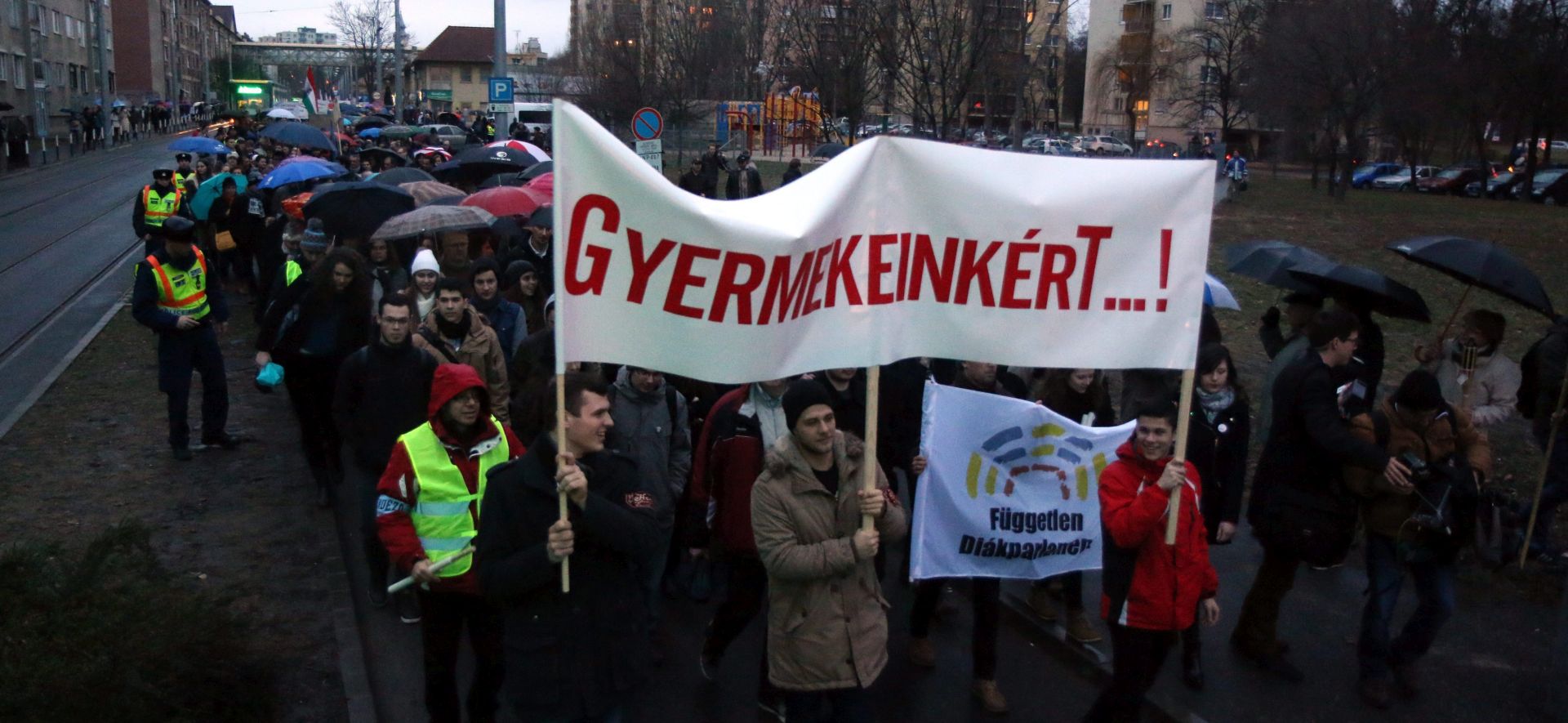 epa05141756 Participants of a teachers' strike march with a banner that reads 'For our children!', near Herman Otto Grammar School in Miskolc, 173 kms northeast of Budapest, Hungary, 03 February 2016. The demonstration dubbed a 'Parent-teacher conference' is staged against the current state of the Hungarian education system.  EPA/JANOS VAJDA HUNGARY OUT