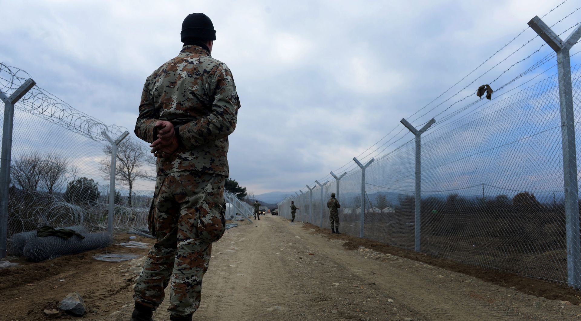 epa05149798 Macedonian soldiers erect a second protective fence on the border line between Greece and Macedonia, near the town of Gevgelija, The Former Yugoslav Republic of Macedonia, 08 February 2016.  Police representatives of the countries of the so-called 'Balkan Corridor' have arranged for the refugees that will transit the Balkan countries, to get a unified and standardized document which will be given to them on the Macedonian-Greek border. This document will contain all necessary information such as identity, age and country of origin but also biometric data such as fingerprints. Refugees without valid documents are not allowed to cross the border.  EPA/NAKE BATEV