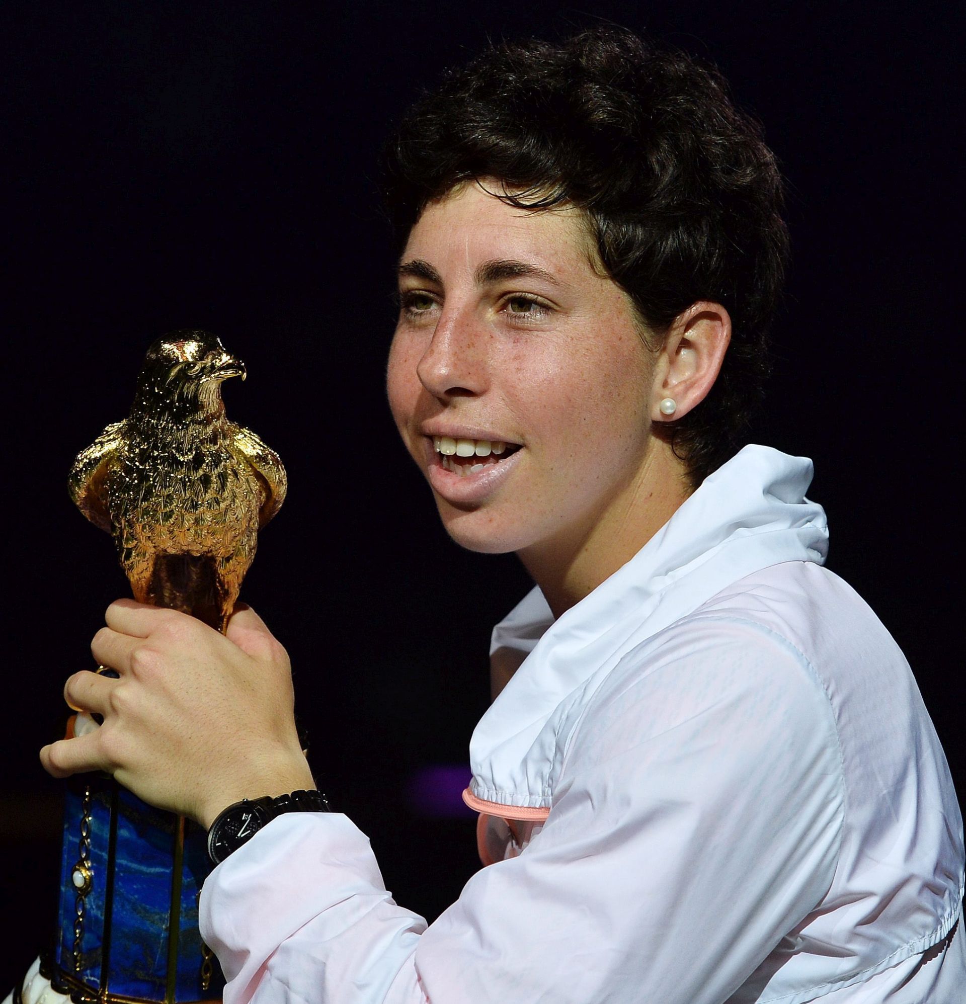 epa05184098 Carla Suarez Navarro of Spain poses with her trophy after beating her opponent Jelena Ostapenko of Latvia during their final match  of the WTA Qatar Ladies Open at the International Khalifa Tennis Complex Doha, Qatar on 27 February 2016  EPA/-
