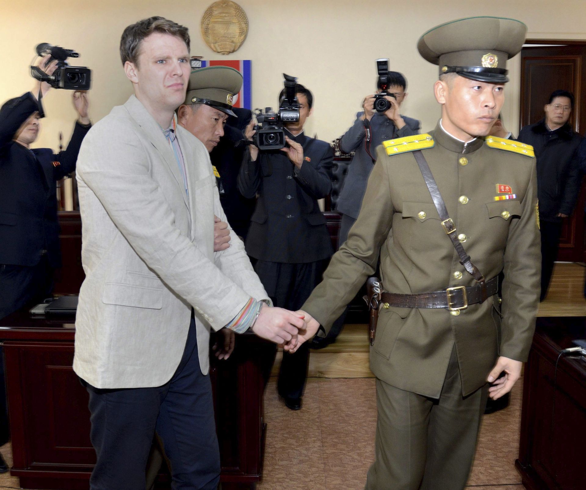 epa05214149 A photo provided by the official Korean Central News Agency (KCNA) shows US student Otto Frederick Warmbier (L) in relation to his trial held by The Supreme Court of the Democratic People's Republic of Korea, in Pyongyang, North Korea, 16 March 2016. Warmbier, a student at the University of Virginia, was sentenced to 15 years in prison for a crime against North Korea, international reports stated. Warmbier was arrested in January for allegedly trying to steal a banner with a political message from his hotel in North Korea.  EPA/KCNA   EDITORIAL USE ONLY