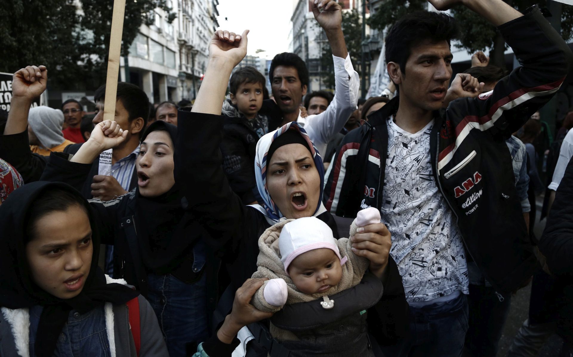 epa05236722 Refugees and migrants who are trapped in Greece shout slogans as they take part in a protest demanding the opening of the borders between Greece and Former Yugoslav Republic of Macedonia (FYROM) in Athens, Greece, 30 March 2016. Migration restrictions along the so-called Balkan route, the main path for migrants and refugees from the Middle East into the European Union, has left thousands of migrants trapped in Greece.  EPA/YANNIS KOLESIDIS