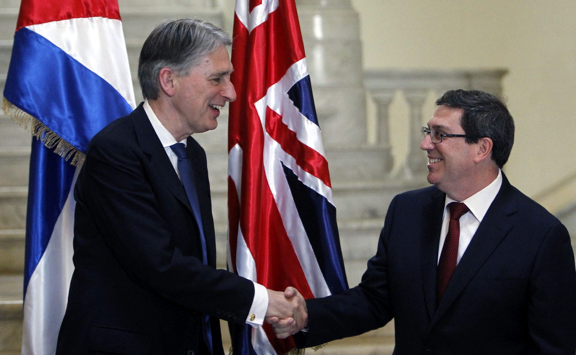 epa05282026 British Secretary of State for Foreign and Commonwealth Affairs, Philip Hammond (L) shakes hands with his Cuban counterpart Bruno Rodriguez Parrilla (R) at the Foreign Ministry headquarters in Havana, Cuba, 28 April 2016. Hammond is in Cuba as part of his Latin American tour, which includes Colombia and Mexico.  EPA/ERNESTO MASTRASCUSA