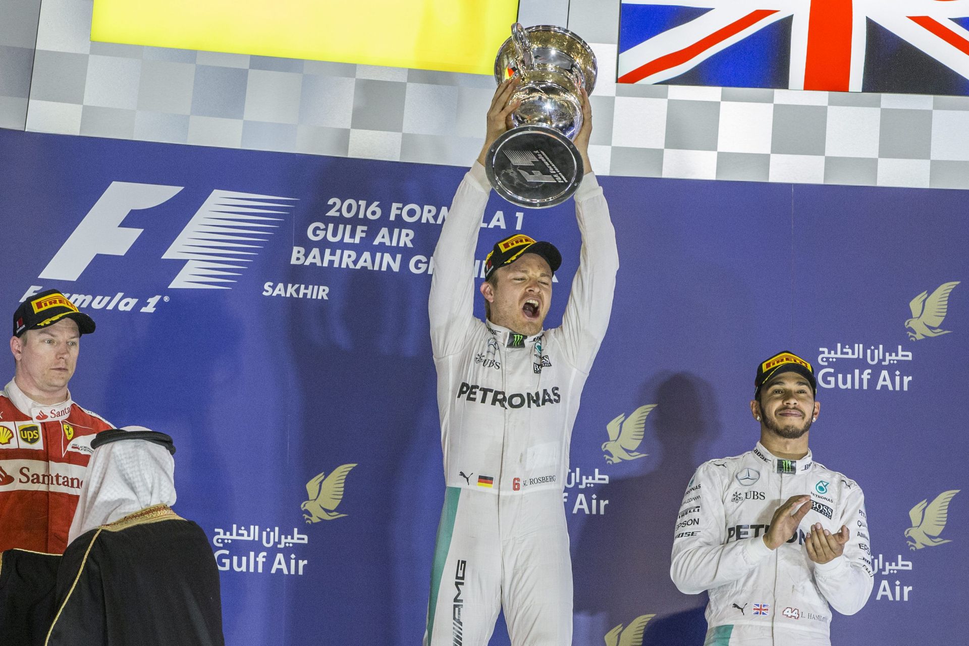 epa05242555 German Formula One driver Nico Rosberg of Mercedes AMG GP (C) celebrates with the trophy after the Bahrain Formula One Grand Prix at the Sakhir circuit near Manama, Bahrain, 04 April 2016.  EPA/VALDRIN XHEMAJ