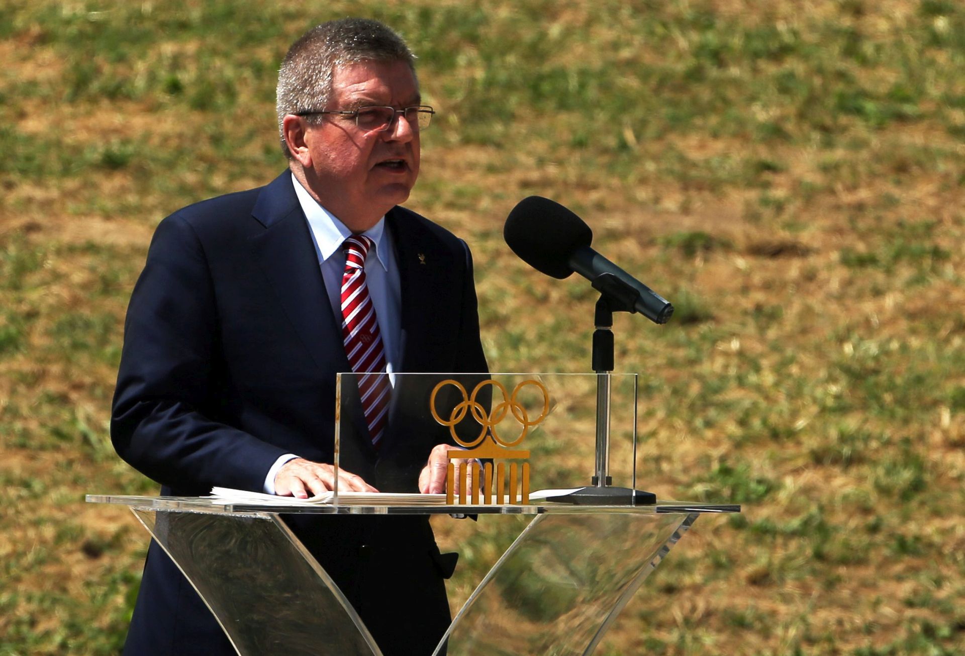 epa05270340 President of the IOC Thomas Bach delivers his speech, during the Lighting Ceremony of the Rio 2016 Olympic Games at the site of ancient Olympia in Greece, 21 April 2016. The Summer Olympic Games will be held in Rio de Janeiro, Brazil from 03 August to 21 August 2016.  EPA/ALEXANDROS VLACHOS