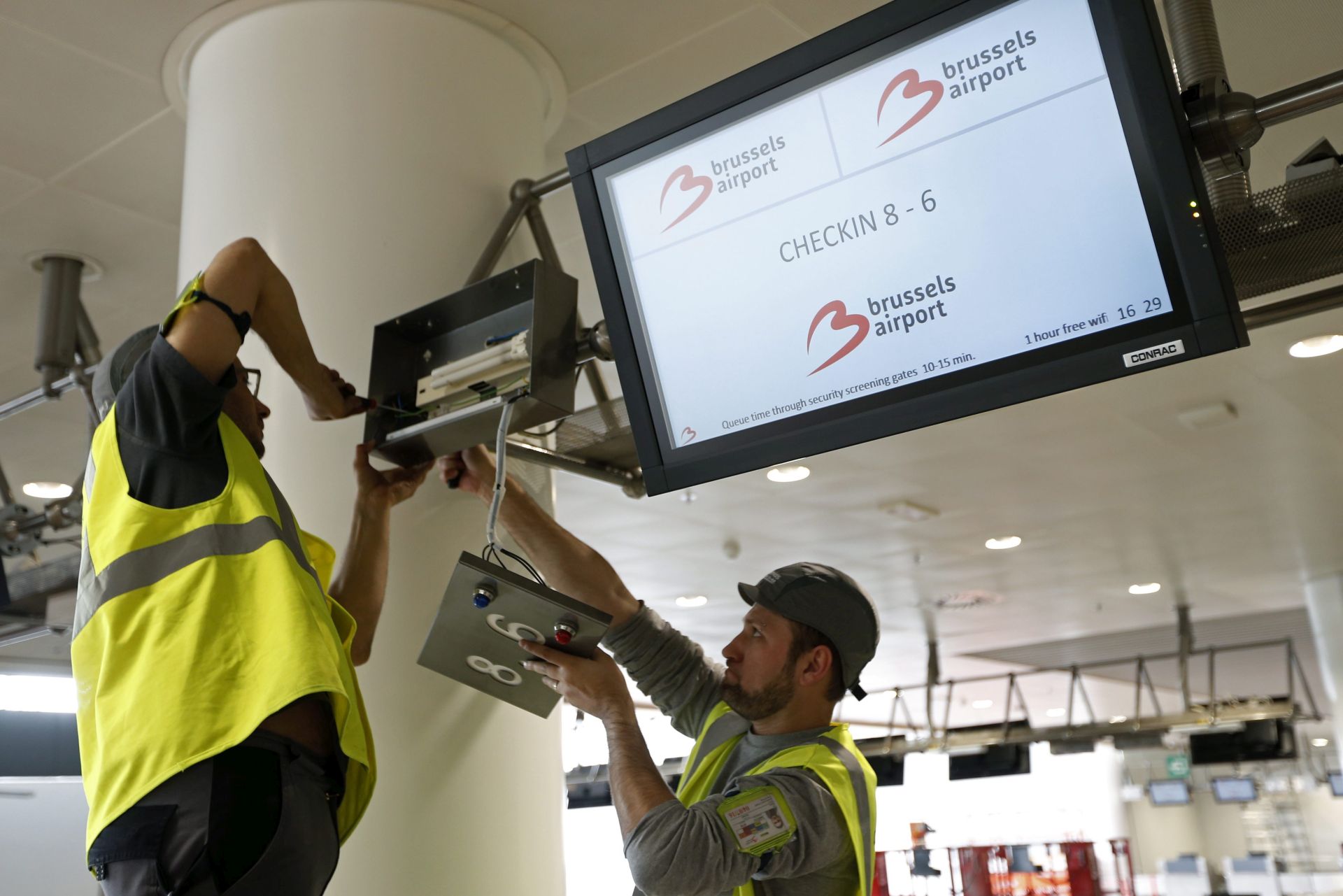 epa05272538 Workers repair a screen as a Parliamentary Committee investigating the Brussels attacks visits the Zaventem airport in Brussels, Belgium, 22 April 2016. At least 31 people were killed and hundreds injured on 22 March 2016 in bomb explosions at the departures hall of the airport and at Metro stations in downtown Brussels. Militants of the terrorist militia refering to itself as Islamic State (IS) have claimed responsibility for the attacks.  EPA/FRANCOIS LENOIR / POOL