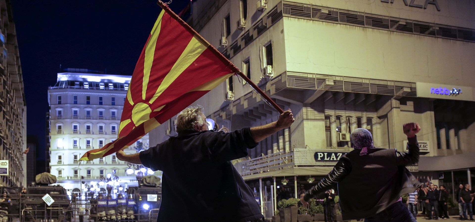 epa05259051 Protestors wave Macedonian flag and hits with stoune to the cordon of special police forces during the protest against Macedonian President Gjorge Ivanov's decision on wiretapping amnesty, in Skopje, Macedonia, 14 April 2016. Ivanov decided to abolish all judicial cases related to the big wire-tapping scandal that brought the country to early general elections scheduled for 05 June. The crisis started in 2015 when opposition SDSM started to publish illegally recorded wire-tapped phone conversations of the highest Governmental officials claiming they show financial crime and eventual evidences of electoral frauds of the ruling conservative VMRO-DPMNE party of then PM Gruevski. Gruevski denied everything saying 'foreign intelligence services' are trying to topple his Government he was administrating from 2006.  EPA/VALDRIN XHEMAJ