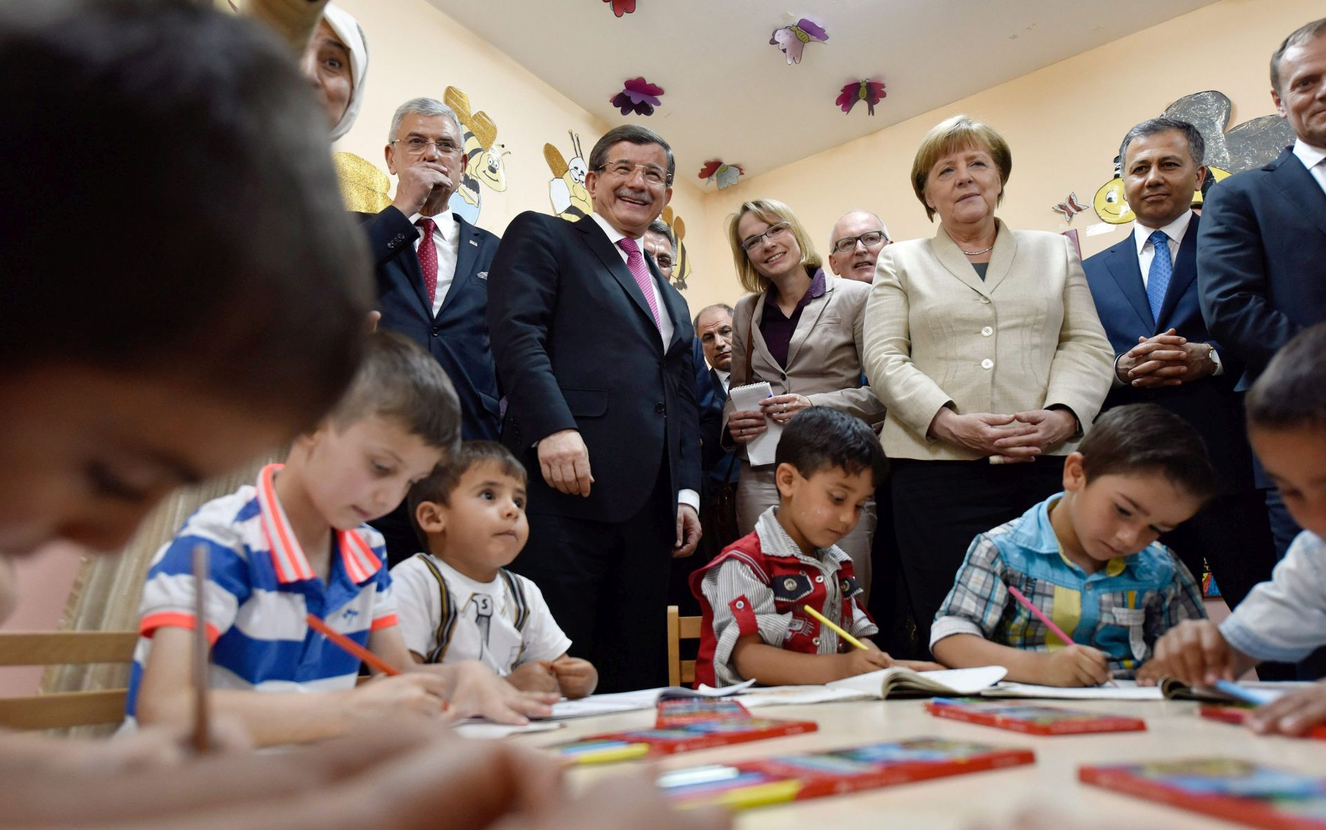 epa05274049 epa05273727 A handout picture provided by the German Federal Government shows German Chancellor Angela Merkel (3-R) as she visits a pre-school class with the Turkish Prime Minister Ahmet Davutoglu (2-L) at the Nizip I refugee camp in Gaziantep, Turkey, 23 April 2016. Merkel travelled to Turkey with the President of the European Council, Donald Tusk, to get informed about the implementation of the EU-Turkey Refugee Agreement.  EPA/STEFFEN KUGLER/GERMAN FEDERAL GOVERNMENT/HANDOUT MANDATORY CREDIT: STEFFEN KUGLER/GERMAN FEDERAL GOVERNMENT HANDOUT EDITORIAL USE ONLY/NO SALES