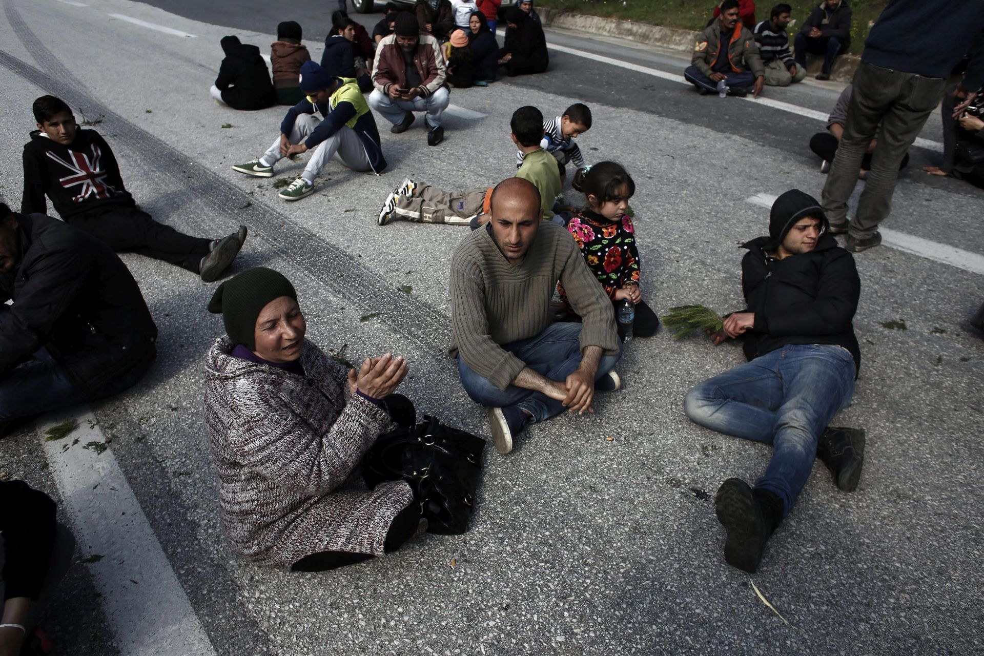 epa05233800 Refugees and migrants block the highway to the border crossing of Evzoni during a protest demanding the opening of the borders near the borders between Greece and FYR of Macedonia,  in northern Greece on 28 March 2016. Migration restrictions along the so-called Balkan route, the main path for migrants and refugees from the Middle East into the European Union, has left thousands of migrants trapped in Greece.  EPA/KOSTAS TSIRONIS
