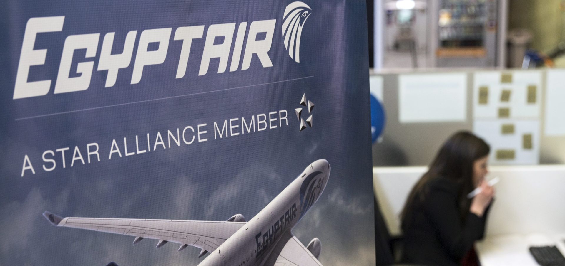 epa05316517 A hostess talks on the phone next to the Egyptair's desk at the Charles de Gaule airport near Paris, France, 19 May 2016. According to media reports quoting Egyptair on 19 May 2016, EgyptAir Airbus A320 Flight MS804 disappeared off radar some 10 miles (16km) after entering Egypt's airspace. The plane, said to be carrying 69 people on board, 59 passengers and 10 crew members, took off from France's Charles de Gaulle airport on 18 May night and was expected to land in Cairo on 19 May early morning.  EPA/ETIENNE LAURENT