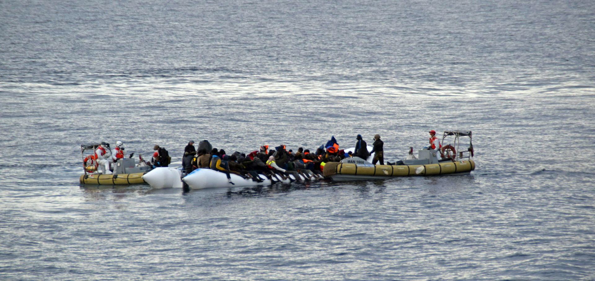 epa05176575 An undated handout image provided by the Italian Navy on 23 February 2016 showing migrants on a boat during rescue operations in the Strait of Sicily off the Italian coast. Italian Navy ships rescued almost 600 migrants from distress during the weekend of 20 and 21 February.  EPA/ITALIAN NAVY / HANDOUT BEST QUALITY AVAILABLE HANDOUT EDITORIAL USE ONLY/NO SALES
