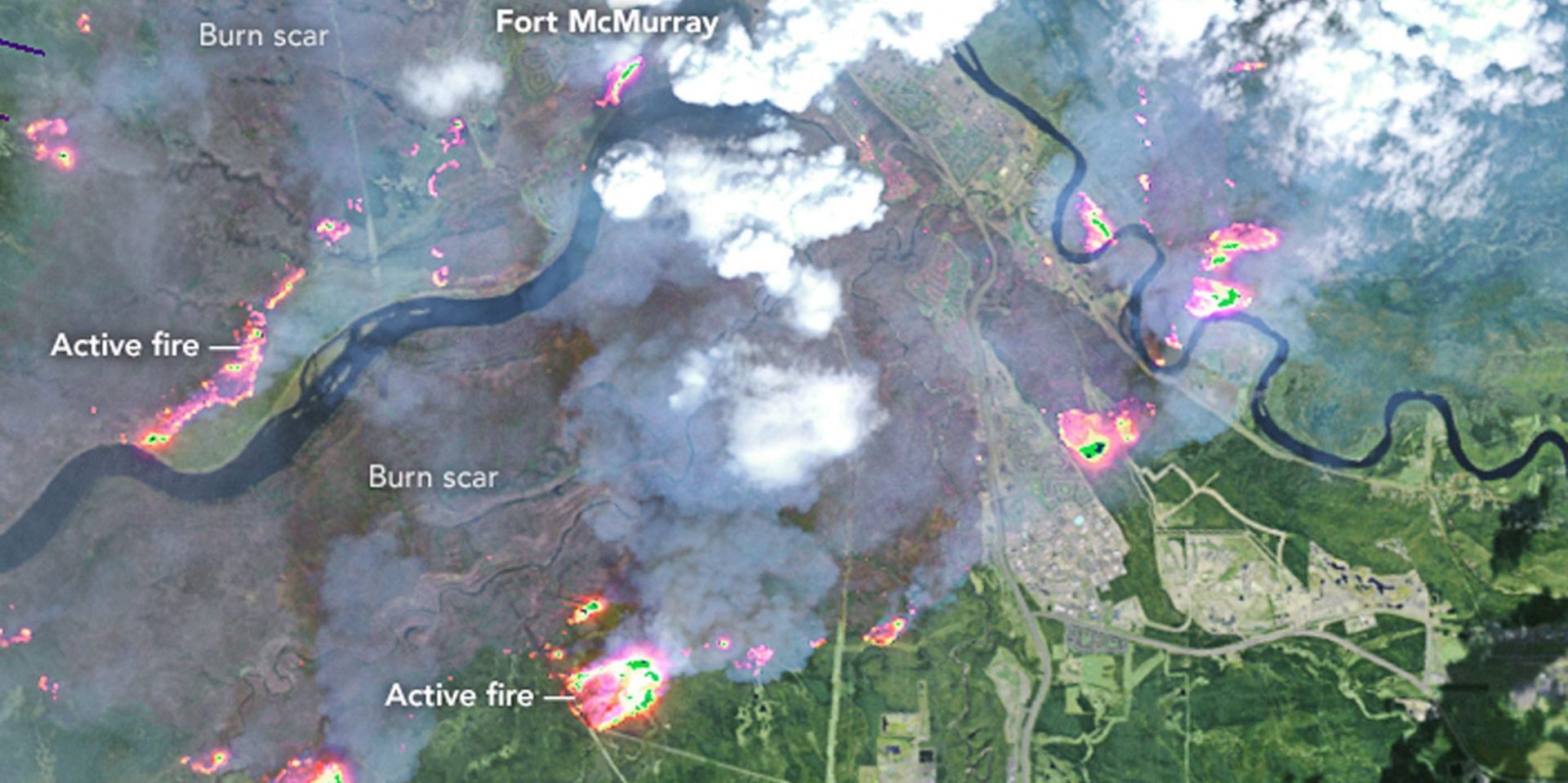 epa05293138 A handout satelite image made avaliable on 07 May 2016 by NASA Earth Observatory showing Fort McMurray on 04 May 2016, acquired by the Enhanced Thematic Mapper Plus (ETM+) on the Landsat 7 satellite. This false-color image combines shortwave infrared, near infrared, and green light (bands 5-4-2). Near- and short-wave infrared help penetrate clouds and smoke to reveal the hot spots associated with active fires, which appear red. Smoke appears white and burned areas appear brown. On this day the fire spanned about 100 square kilometers (40 square miles); by the morning of 05 May, it spanned about 850 square kilometers (330 square miles). Reports on 07 May 2016 state that the wildfire which has destroyed Fort McMurray could double in size over the next 24 hours as the fire is being fanned by winds and feeding on dry vegetation.  EPA/NASA EARTH OBSERVATORY / HANDOUT  HANDOUT EDITORIAL USE ONLY/NO SALES