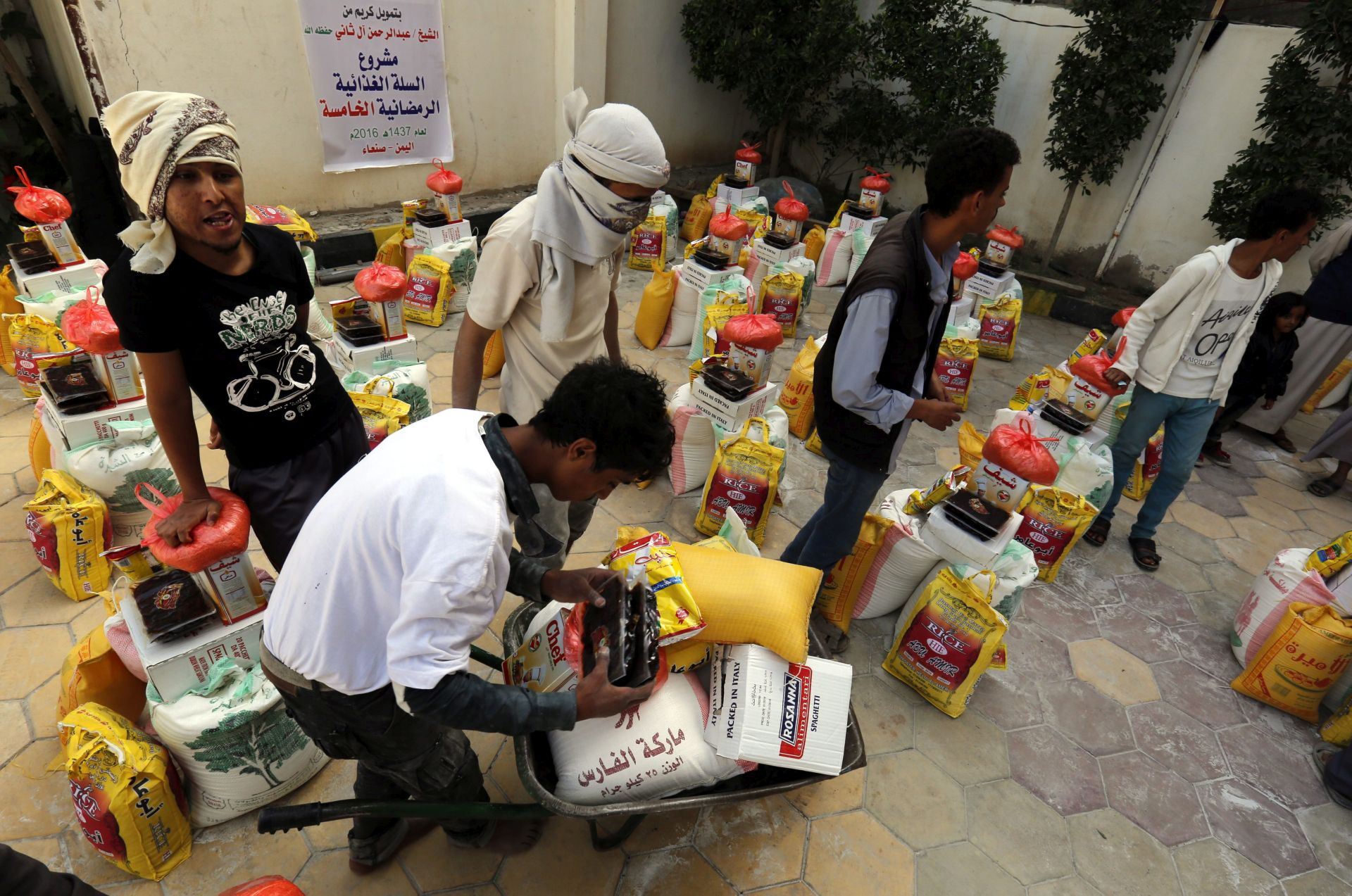 epa05341567 Conflict-affected Yemenis receive food rations provided by a local relief group, in Sanaa, Yemen, 02 June 2016. According to reports, the year-long conflict has worsened Yemen's already poor food security situation, leaving 21 million people of the countrys 24 million-population facing severely shortages of food and vital supplies 2.5 million others forcibly displaced.  EPA/YAHYA ARHAB  EPA/YAHYA ARHAB