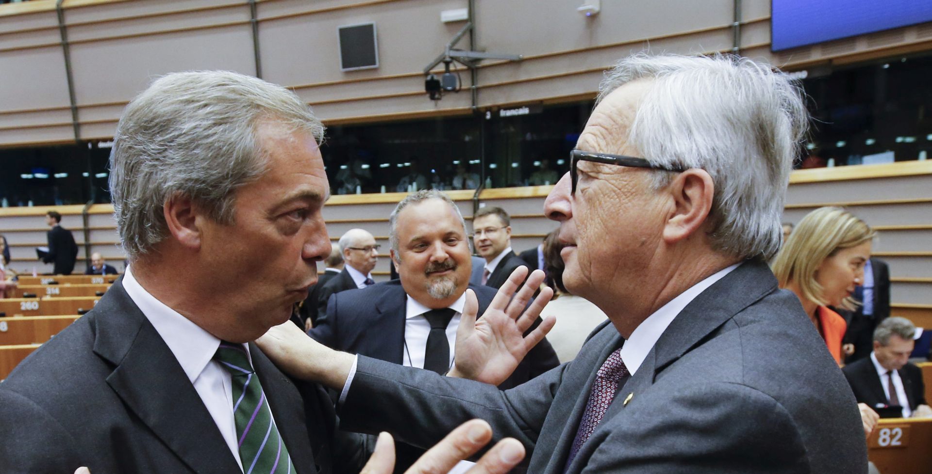 epa05395717 Nigel Farage (L), leader of the United Kingdom Independence Party (UKIP), chats with European Commission President Jean- Claude Juncker (R) at the start of a plenary session of the European Parliament, in Brussels, Belgium, 28 June 2016. The session will focus on the so-called 'Brexit' and is held ahead of a EU Summit. Later this afternoon EU leaders will met for the first time since the British referendum, in which 51.9 percent voted to leave the European Union (EU).  EPA/OLIVIER HOSLET