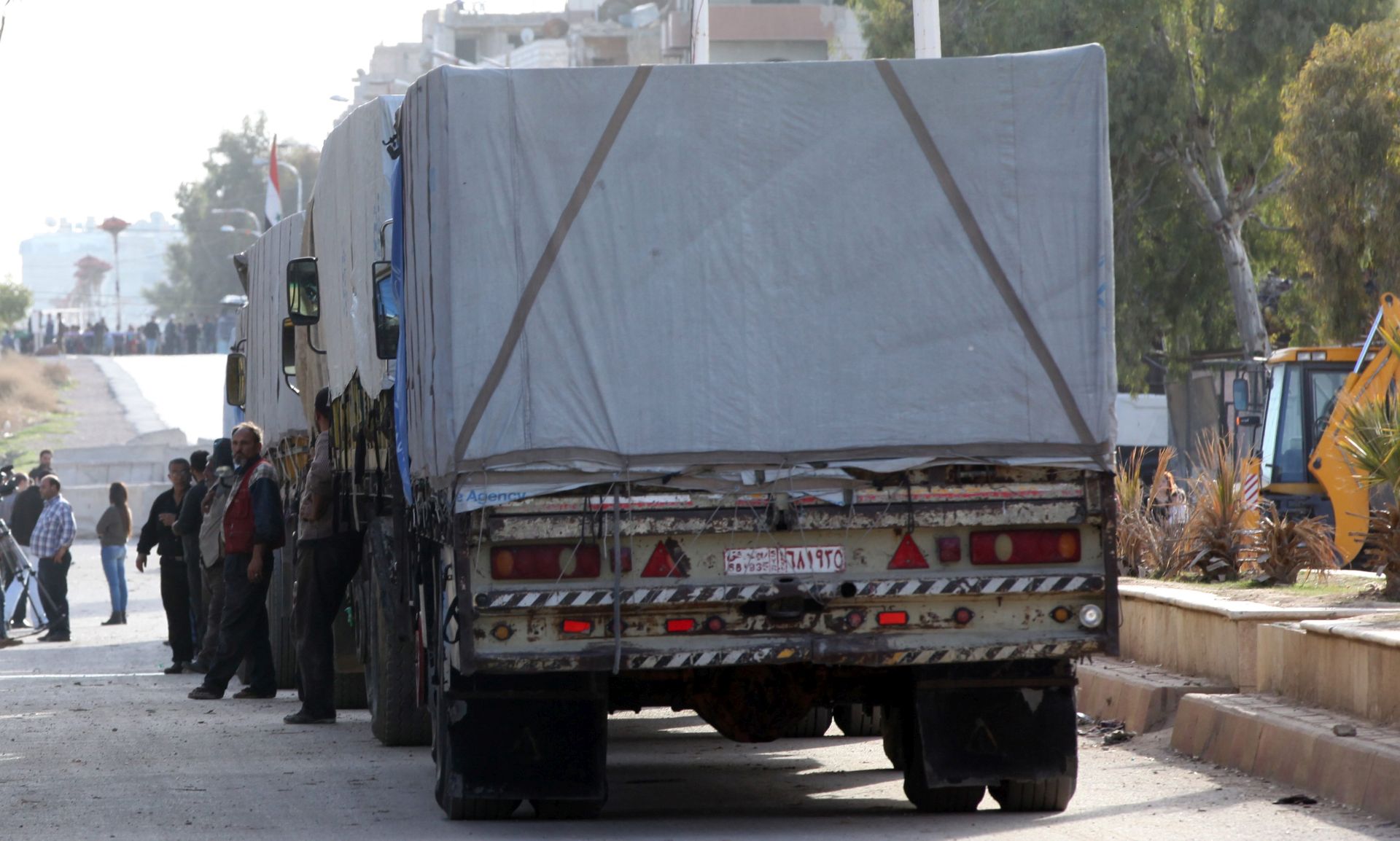 epa05166729 Trucks with relief goods head to al-Moaddamiyeh town in the countryside of Damascus, Syria, 17 February 2016. Around 73 trucks loaded with food, infant formula and medicines, in addition to a mobile clinic and a medical team, will head to the besieged rebel-held towns of Madaya, al-Zabadani and al-Moadhamiya, as part of a UN sponsored aid operation in the war-torn country. A similar convoy of 25 trucks, a mobile clinic and a medical team, headed to the villages of Foua and Kfraya in the northern Idlib, which are besieged by rebels. The convoys are the third humanitarian aid delivery to the besieged areas after two similar efforts last month.  EPA/YOUSSEF BADAWI