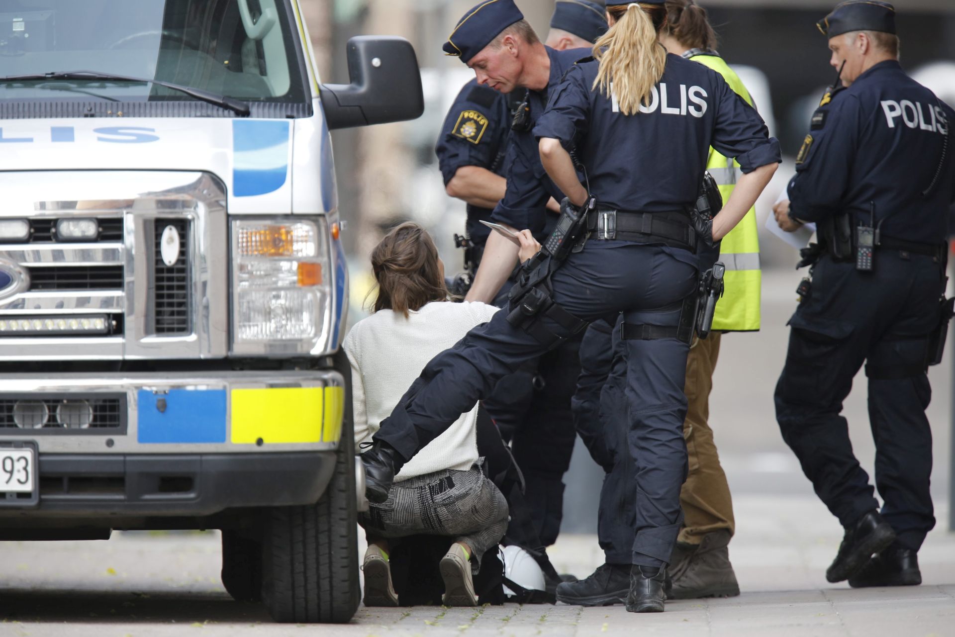 epa05366182 Swedish police checks the papers and backpack of a young woman after two men and two women earlier were arrested after treepassing the main entrance and a roof to the Swedish government's seat 'Rosenbad' in Stockholm, 15 June 2016. Anti-coal activists which reportedly were from England, Germany, Denmark and Sweden deployed a banner with a slogan reading: 'Let the coal stay where it is' in front of the Prime Minister's office in Stockholm to oppose the coal policy of Swedish state-owned energy giant Vattenfall.  EPA/CHRISTINE OLSSON SWEDEN OUT