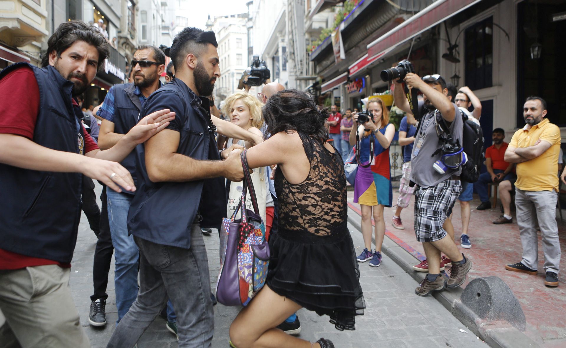 epa05392667 A participant is arrested by Turkish police during Istanbul LGTB Pride Parade which was cancelled due to security concerns by the governor of Istanbul, in Istanbul, Turkey, 26 June 2016. Transgenders people and supporters try to march in central Istanbul as part of the Trans Pride Week 2016, which is organized by Istanbul's 'Lesbians, Gays, Bisexuals, Transvestites and Transsexuals' (LGBT) solidarity organization.  EPA/CEM TURKEL