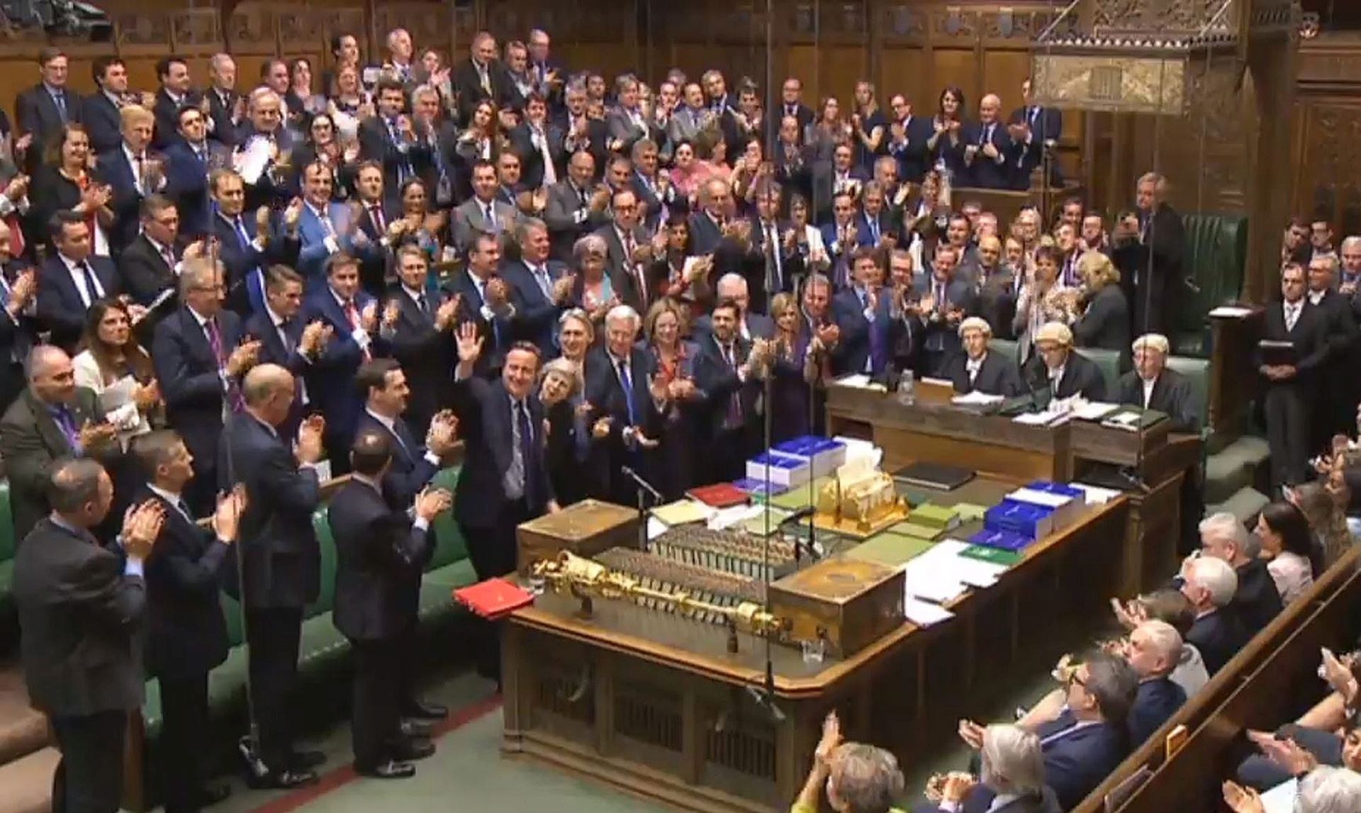 epa05423024 A British Parliament handout photo released on 13 July 2016 shows Conservative Members of Parliament giving outgoing Prime Minister David Cameron (C-L, waving) a standing ovation after finishing his last Prime Minister's Questions in the House of Commons, in London, Britain, 13 July 2016. Later in the day current Home Secretary Theresa May will succeed Cameron as Prime Minister after a meeting with the Queen.  EPA/PARLIAMENT/HANDOUT UK AND IRELAND OUT * BEST QUALITY AVAILABLE HANDOUT EDITORIAL USE ONLY/NO SALES/NO ARCHIVES