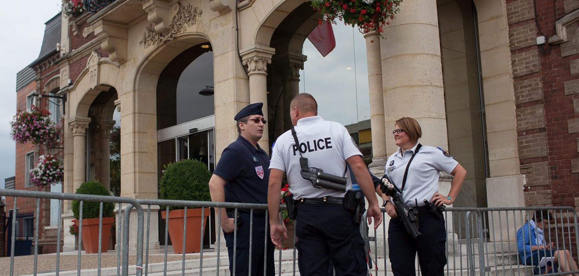 epa05442141 Police officers on guard in front of the city hall after a fatal hostage taking incident at a church in Saint-Etienne-du-Rouvray, near Rouen, France, 26 July 2016. According to reports, two hostage takers were killed by the police after they took hostages at a church in Saint Etienne du Douvray. One of the hostages, a priest was killed by one of the perpetrators.  EPA/JULIEN PAQUIN