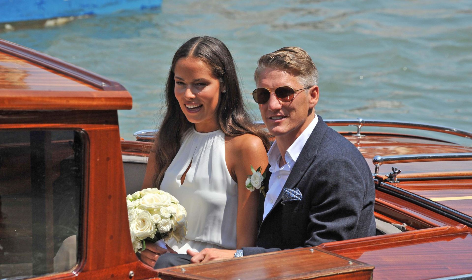 epa05421771 Serbian tennis player Ana Ivanovic and German soccer player Bastian Schweinsteiger sit on a boat after their wedding in Venice, Italy, 12 July 2016. Schweinsteiger plays as a midfielder for English club Manchester United and in the Germany national team.  EPA/ANDREA MEROLA