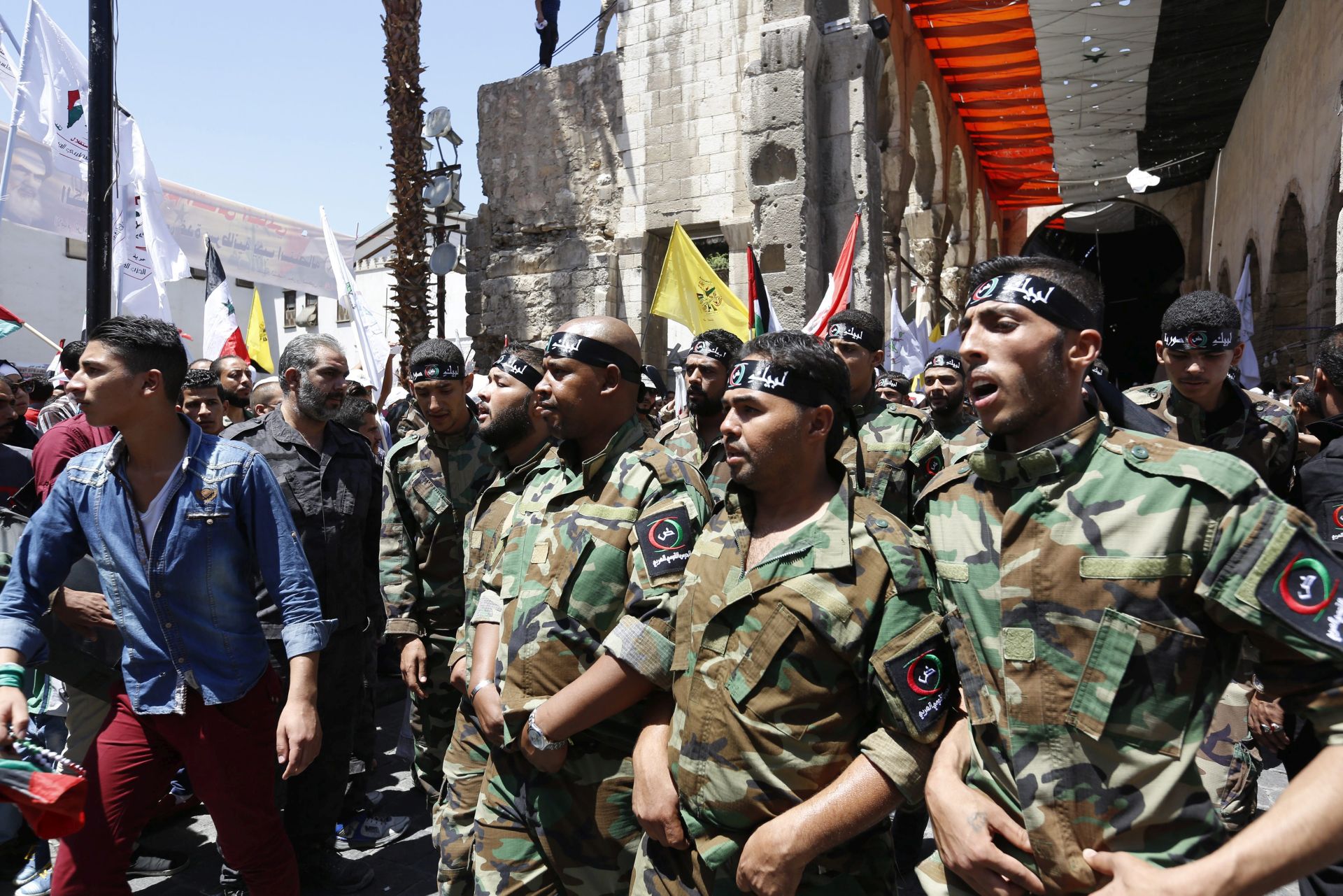epa05400866 Protesters take part in a march marking Al-Quds day (Jerusalem Day) in the Old City of Damascus, Syria, 01 July 2016. Many Muslim countries mark Al-Quds Day, an annual day of protest decreed in 1979 by the late Iranian ruler Ayatollah Khomeini, on the last Friday of Ramadan. The day is celebrated in a move to express support for the Palestinian people and their resistance against Israeli occupation.  EPA/YOUSSEF BADAWI