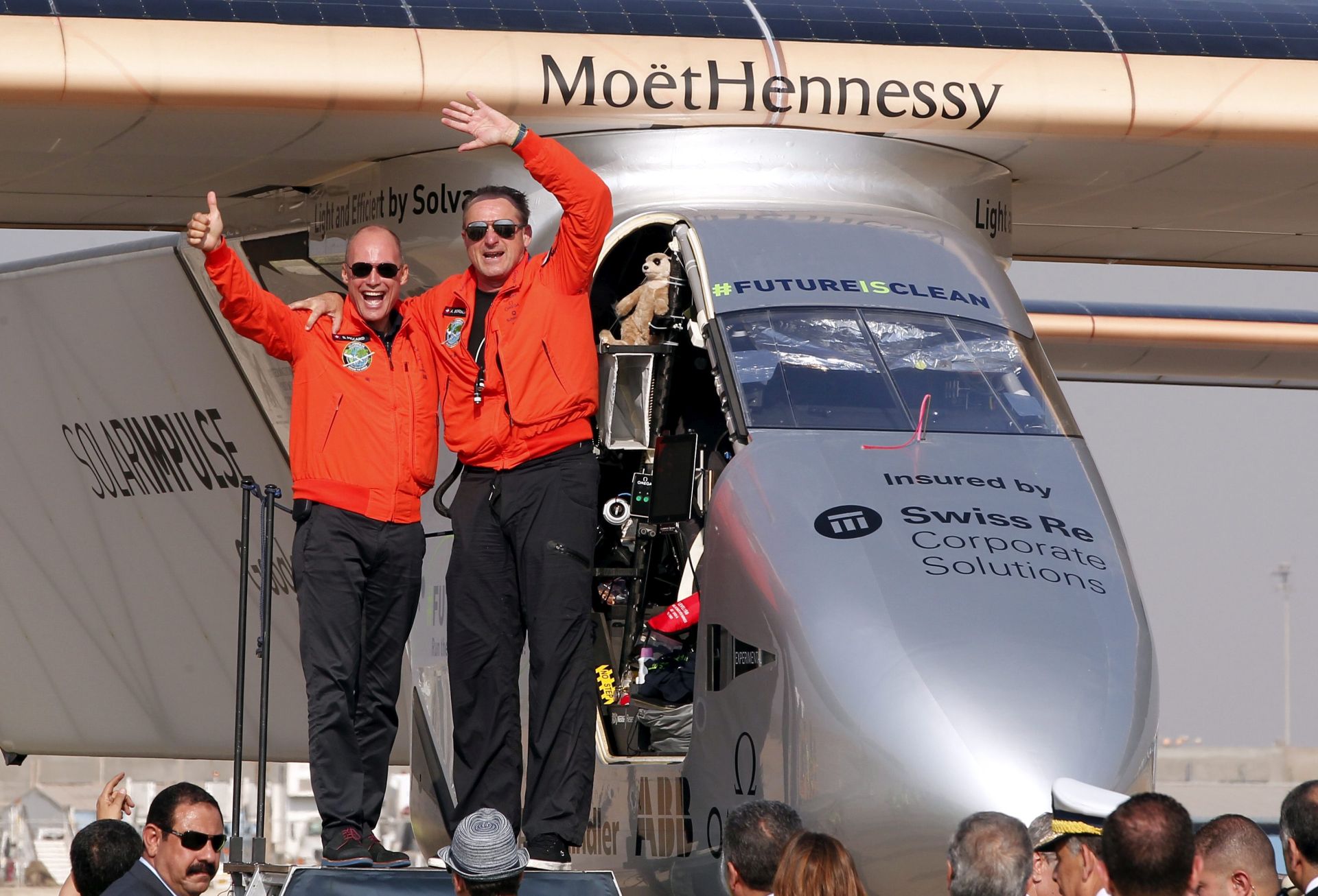 epa05422605 Swiss pilot Bertrand Piccard (L) and pilot Andre Borschberg (R) cheer after Solar Impulse 2, the solar powered plane, landed at Cairo International Airport in Cairo, Egypt, 13 July 2016. The 16th leg of the round-the-world-trip from Seville in Spain covered a distance of 3,700km and took almost 49 hours.  EPA/KHALED ELFIQI