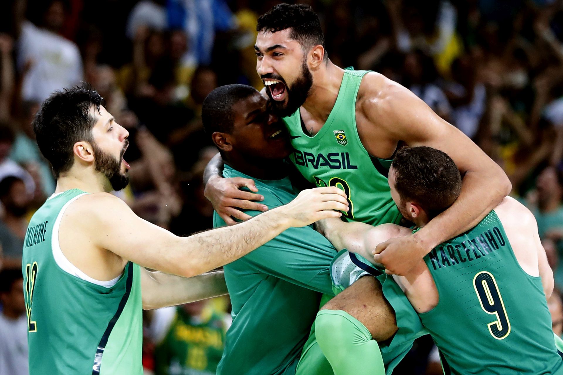 epa05468553 Brazil's Lima Augusto (2R) Marcelinho Huertas (R), Guilherme Giovannoni (L) and Felicio Cristiano (2L) celebrate as they play Spain during the men's basketball game of the Rio 2016 Olympic Games at the Carioca Arena 1 in the Olympic Park in Rio de Janeiro, Brazil, 09 August 2016.  EPA/JORGE ZAPATA