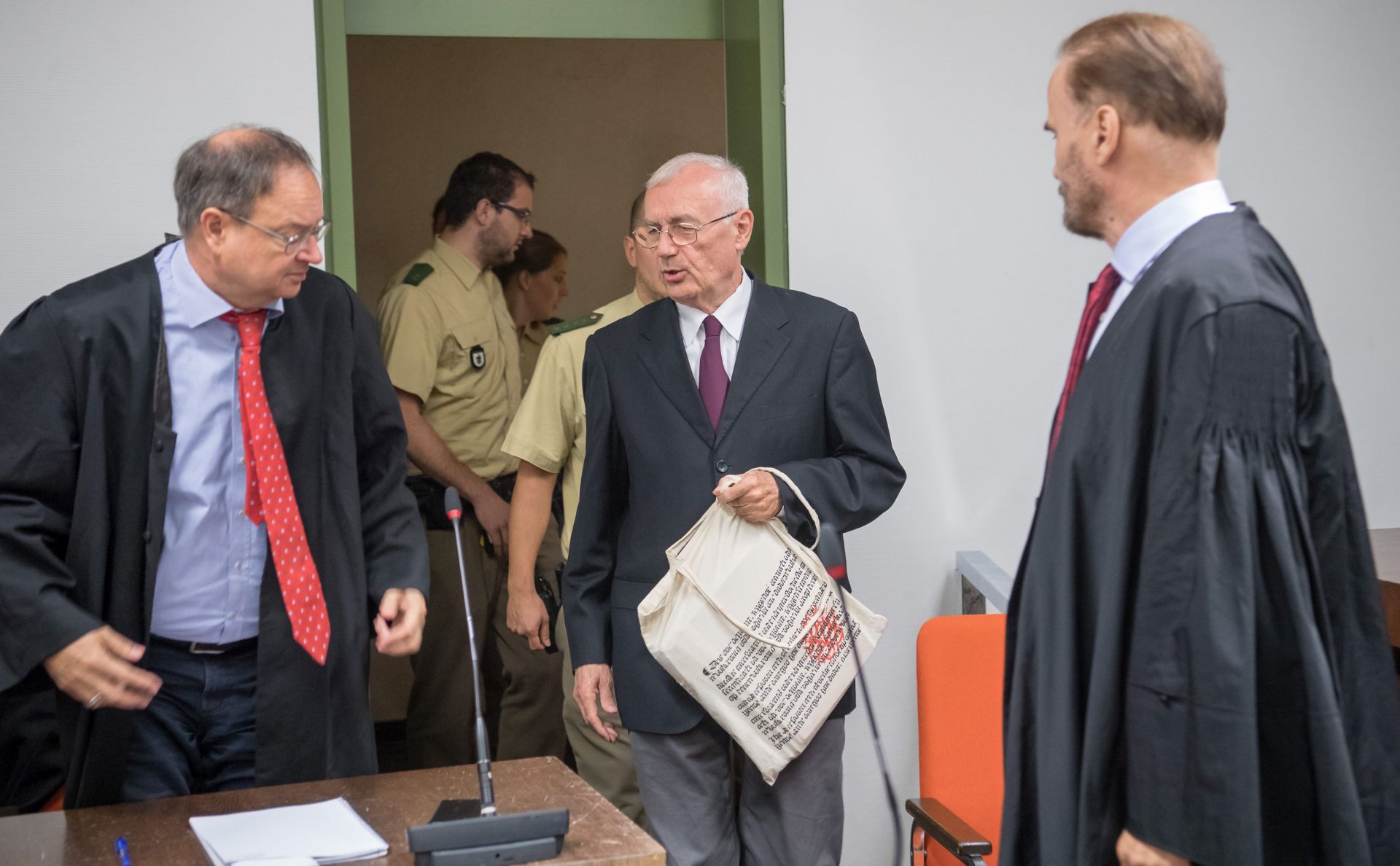 epa05452808 The former head of the Yugoslavian secret service, Zdravko Mustac 
(C), enters the courtroom of the Higher Regional Court in Munich, Germany, 03 August 2016.  The verdict in the trial for the violent death of an exiled Croatian 33 years ago, will be announced on 03 August. For 21 months a state security senate with the Munich Higher Regional Court had been holding trial against the head of the former Yugoslavian secret service SDS and a department head for accessory to murder.  EPA/PETER KNEFFEL