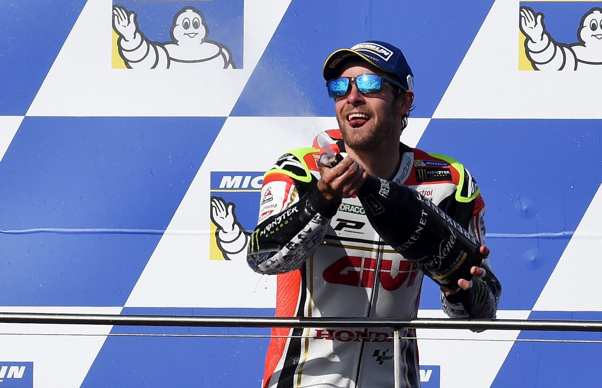 epa05598782 Britain's Cal Crutchlow of LCR Honda (R) sprays champagne as he celebrates his win after the 2016 Australian MotoGP, Philip Island, Victoria, Australia, 23 October 2016.  EPA/TRACEY NEARMY AUSTRALIA AND NEW ZEALAND OUT