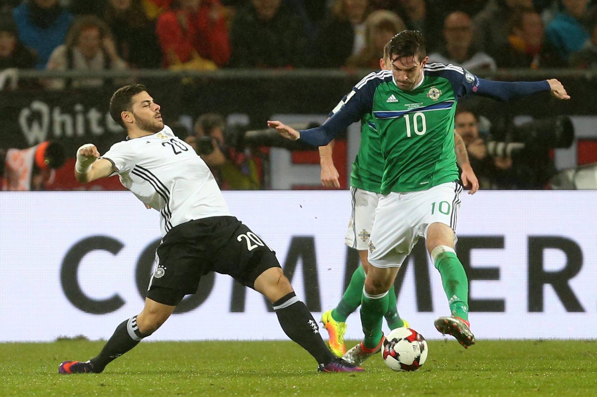 epa05581607 German Kevin Volland and Kyle Lafferty of Northerin Ireland in action during a FIFA World Cup qualifying match between Germany and Northern Ireland the HDI Arena in Hanover, Germany, 11 October 2016.  EPA/FRISO GENTSCH