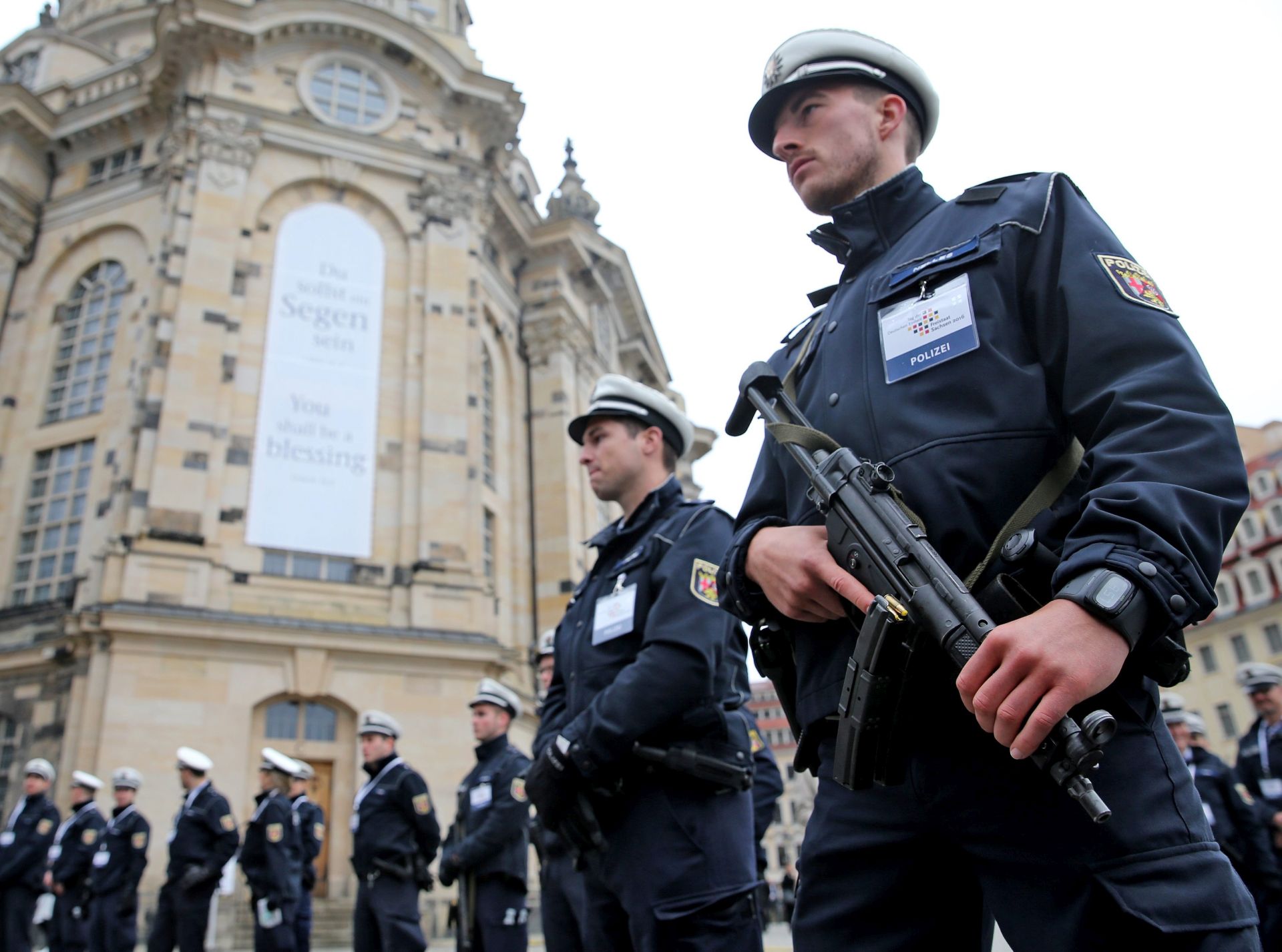 epa05567901 Armed German police secures the Neumarkt square in front of the 'Frauenkirche' (Church od Our Lady), in Dresden, Germany, 03 October 2016. The highest representatives of the state, including German President Gauck, 'Bundestag' parliament president Lammert, German Chancellor Merkel and Constitutional Court President Vosskuhle are expected in Dresden for this year's central celebrations to mark the 26th anniversary of the nation's peaceful reunification, known as the 'Day of German Unity', in Dresden on 03 October 2016.  EPA/JAN WOITAS