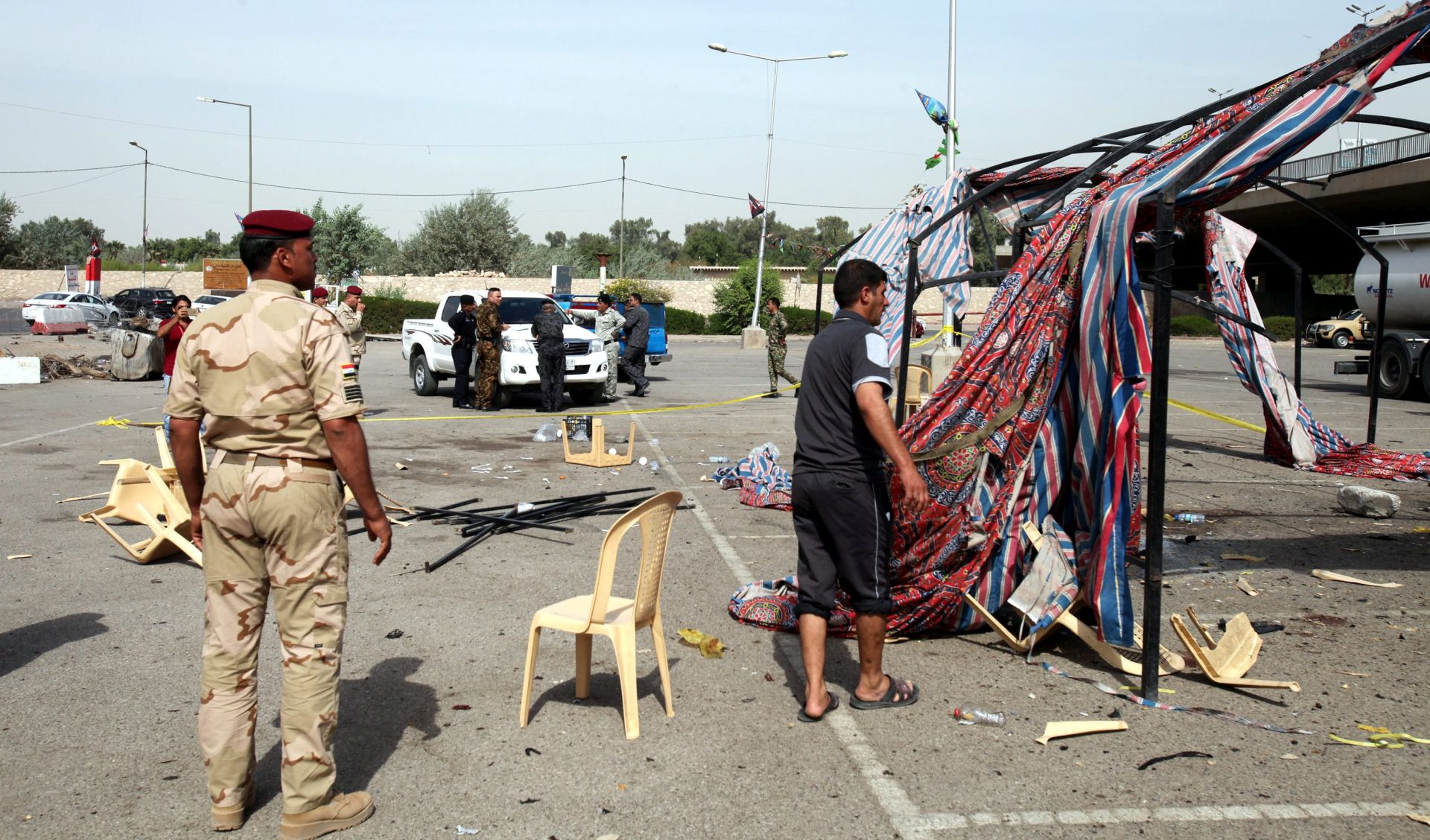 epa05587712 Iraqi policemen inspect the scene of a suicide bomb attack at Jadriyah district in central Baghdad, Iraq, 16 October 2016. At least four Shiites worshipers were killed and seven others were wounded when a suicide bomber blew himself inside a tent built to celebrate the annual Shiite Ashura festival in Baghdad, security officials said.  EPA/ALI ABBAS