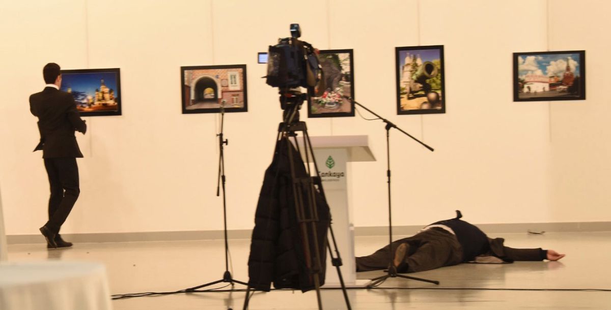 epa05682622 Gunman (L) stands near slain Russia's ambassador to Turkey, Andrey Karlov's body (R) after he shot him during an art exhibition in Ankara, Turkey, 19 December 2016. Russia's ambassador to Turkey, Andrey Karlov, has been shot at an art exhibition in the Turkish capital of Ankara.Karlov has died of his wounds after the attack, Russia's Ministry of Foreign Affairs confirmed.  EPA/DEPO PHOTOS TURKEY OUT