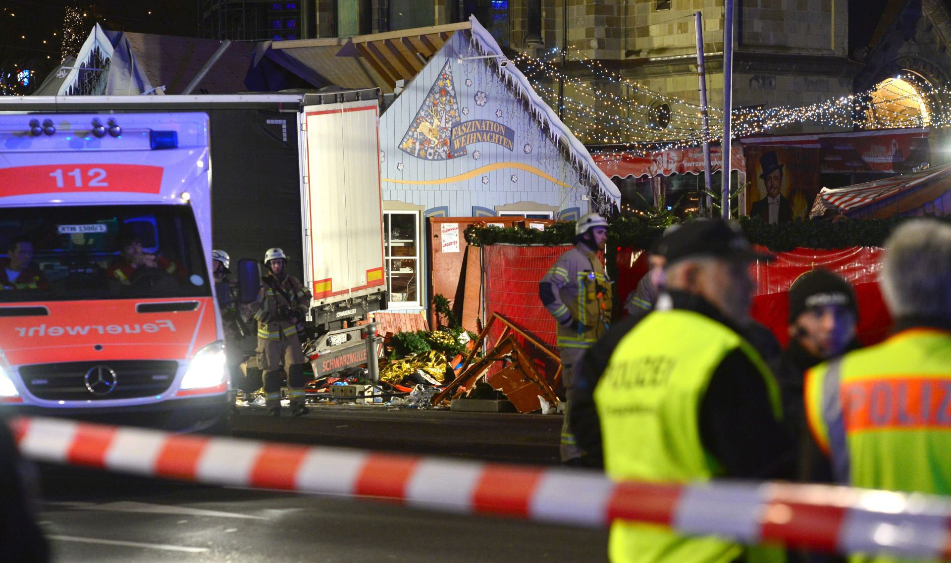 epa05682778 Rescue workers inspect the scene where a truck crashed into a Christmas market, close to the Kaiser Wilhelm memorial church in Berlin, Germany, 19 December 2016. According to the police, several people are reported killed and many injured in what police suspect it was a deliberate attack.  EPA/MAURIZIO GAMBARINI