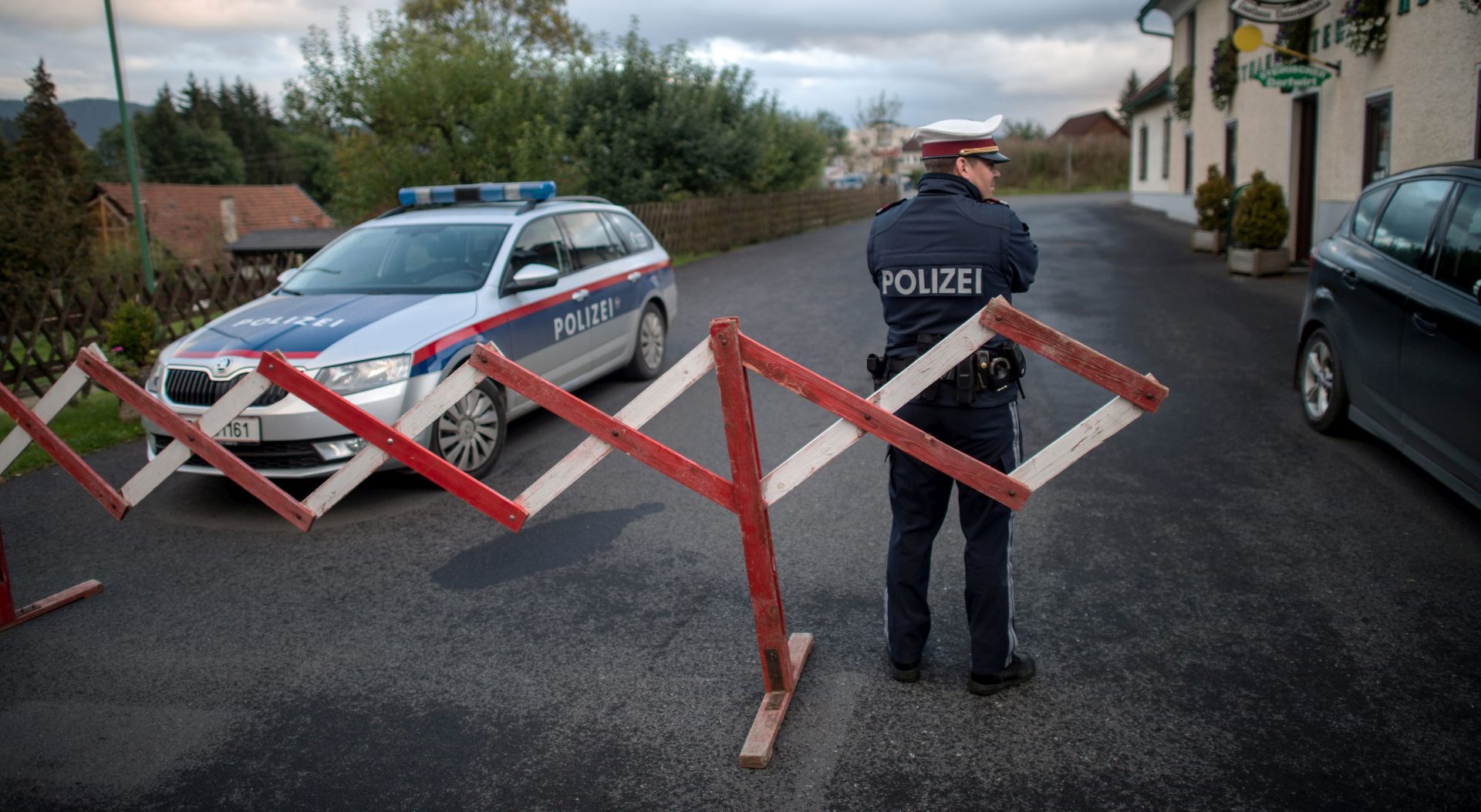 epa05575078 An Austrian police officer blocks a road next to a crime scene in Trofaiach, Austria, 07 October 2016. According to local media a 23-year-old police officer was arrested earlier this day after he confessed the murders of his 25-year-old wife and  one-year-old child. The man reported that his wife and child is missing on 03 October 2016.  EPA/CHRISTIAN BRUNA