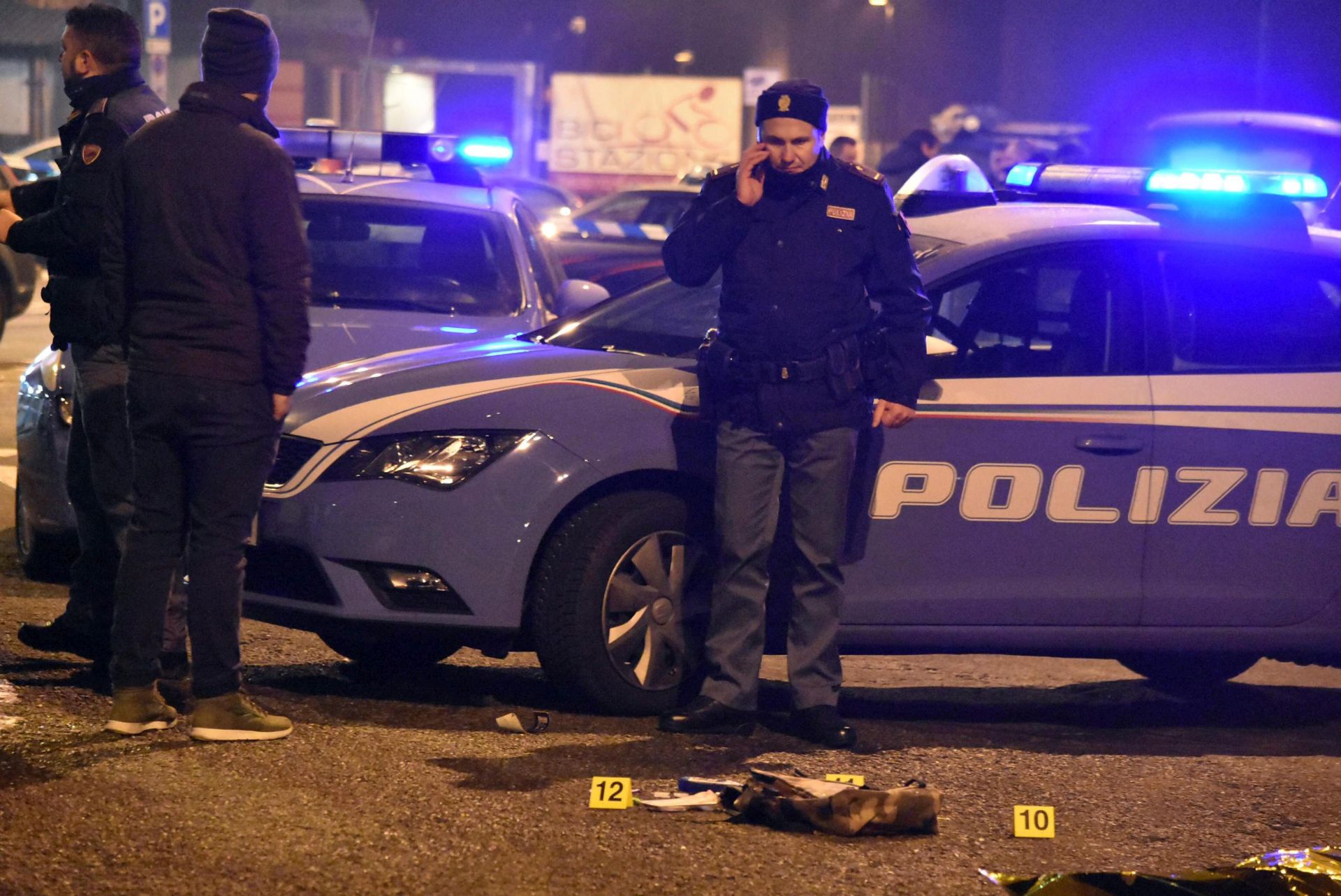 epa05686394 Italian police stand near the scene of a shootout between police and a man in Milan's Sesto San Giovanni neighborhood, early 23 December 2016. Italy's Interior Minister Marco Minitti meanwhile has confirmed that the identity of the individual shot dead after a gunfight with Italian police this morning near Milan is Anis Amri, the 24 year old Tunisian suspected of the 19 December Berlin Christmas Market terrorist truck attack, that left at least 12 people dead and around 50 others injured.  EPA/DANIELE BENNATI