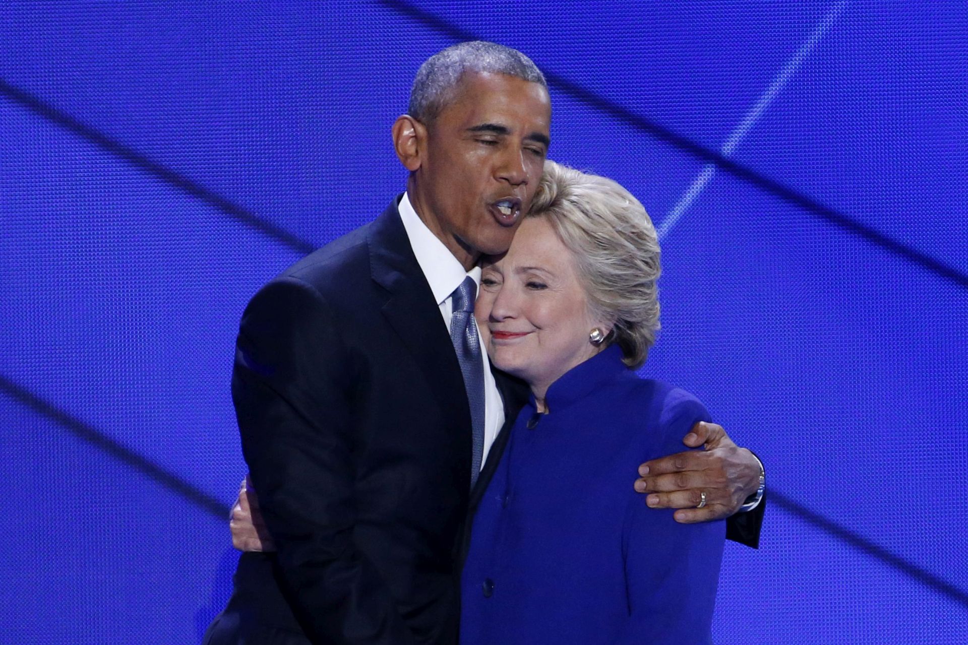 epa05444882 US President Barack Obama (L) hugs Democratic nominee for President Hillary Clinton (R) on stage on the third day of the Democratic National Convention at the Wells Fargo Center in Philadelphia, Pennsylvania, USA, 27 July 2016. The four-day convention is expected to end with Hillary Clinton formally accepting the nomination of the Democratic Party as their presidential candidate in the 2016 election.  EPA/SHAWN THEW